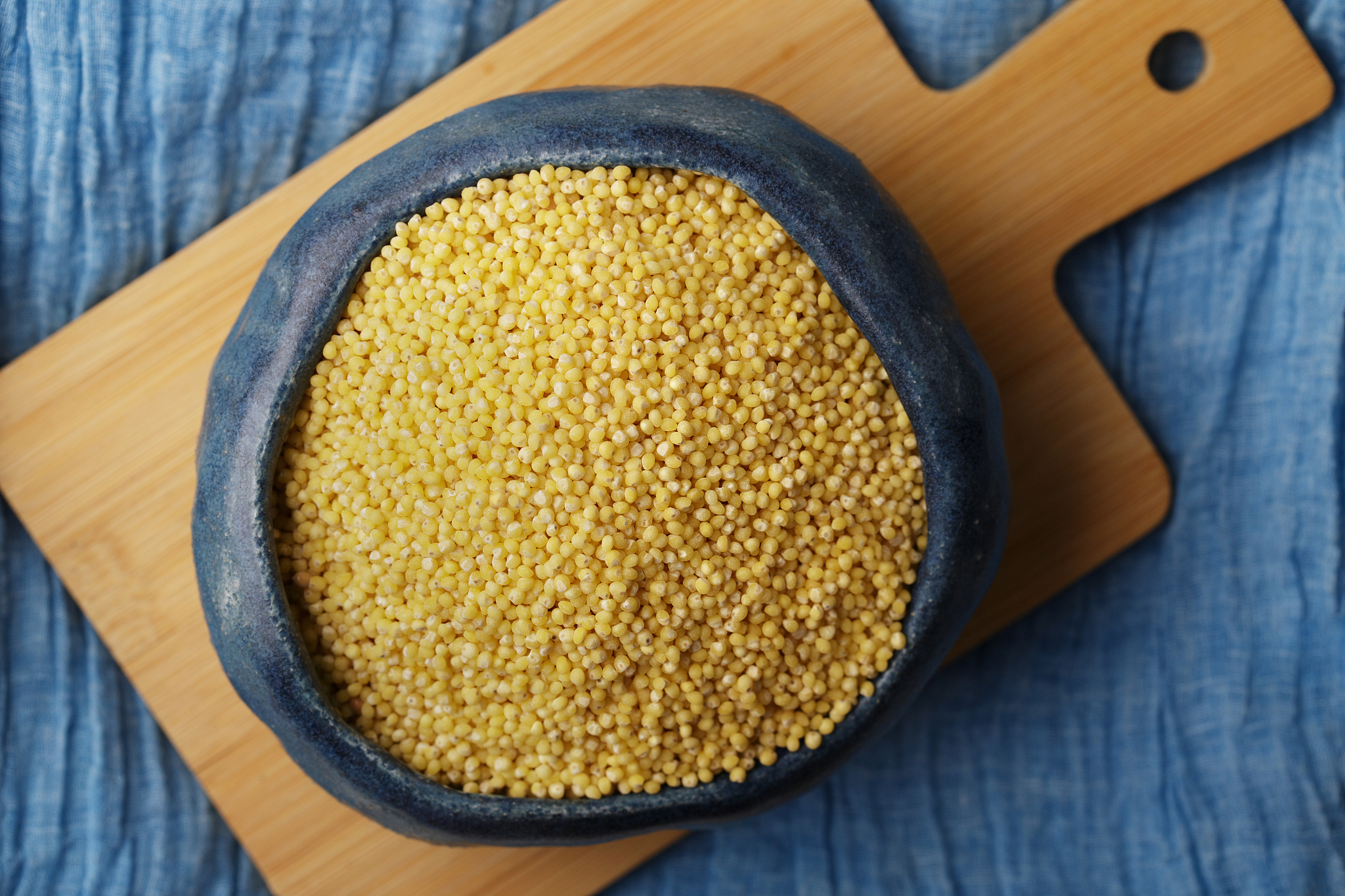 millet or foxtail grains in bowl, top view