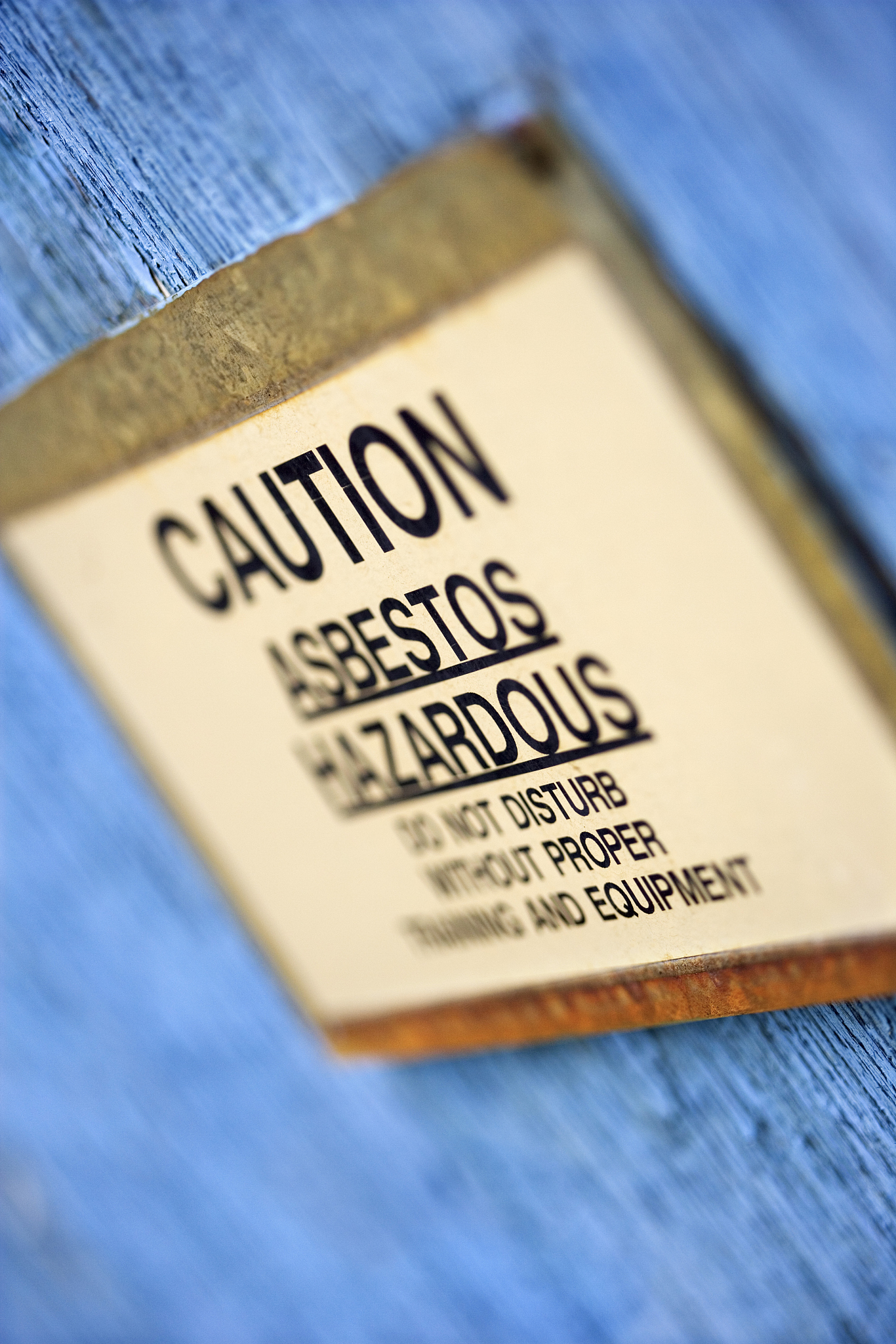 caution signing warning of asbestos hazard