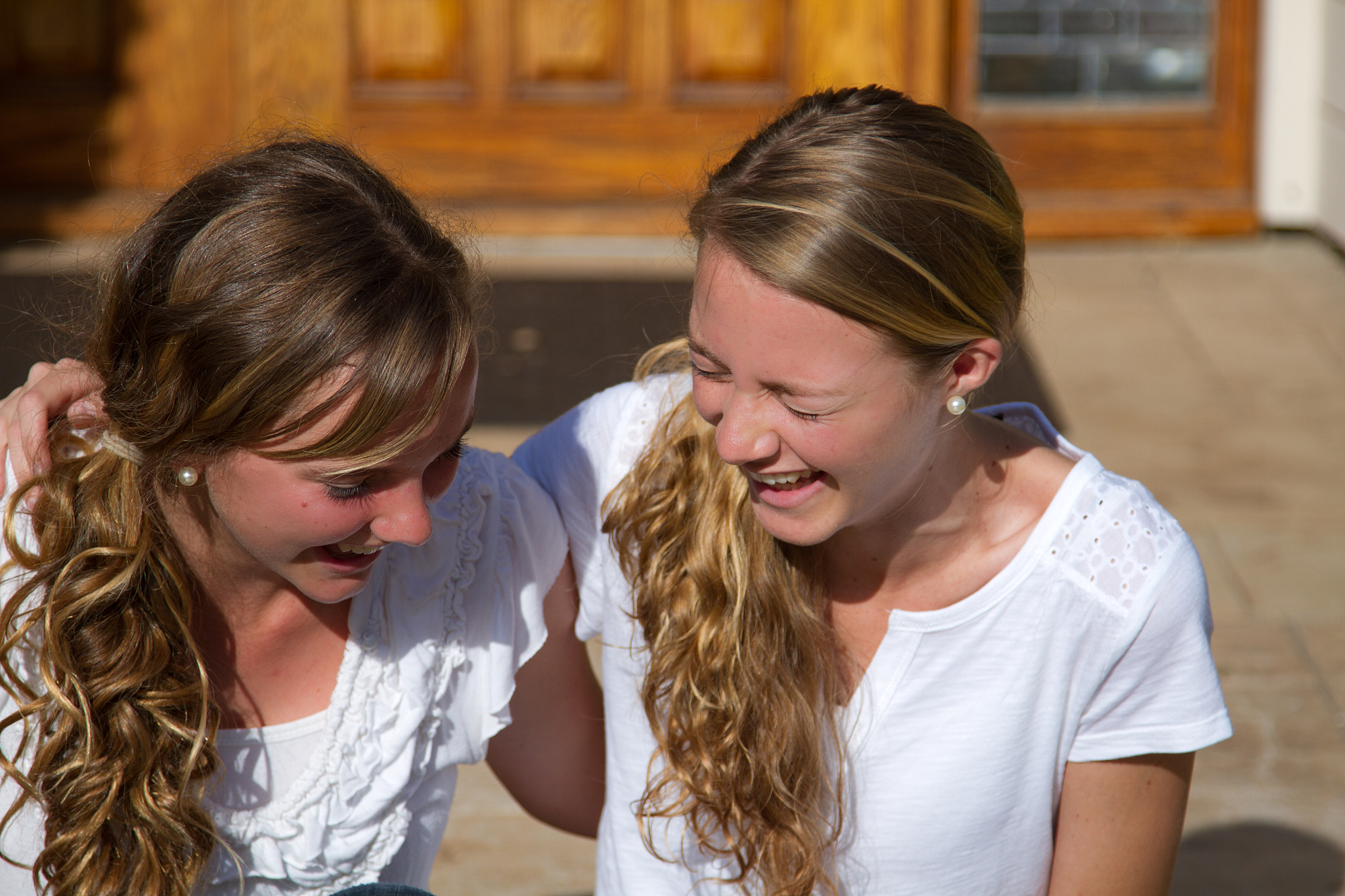 two teen female friends laughing together