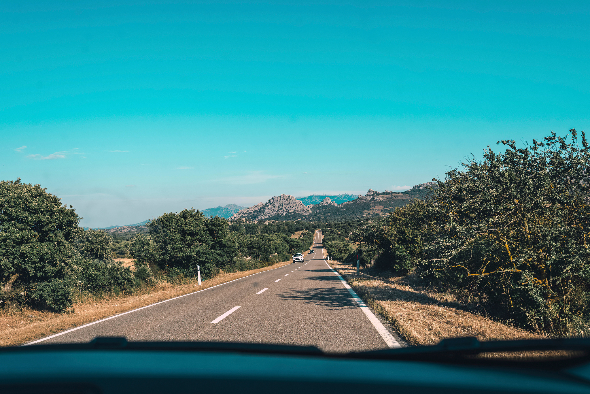 road with mountain landscape seen through windshield of car. sar