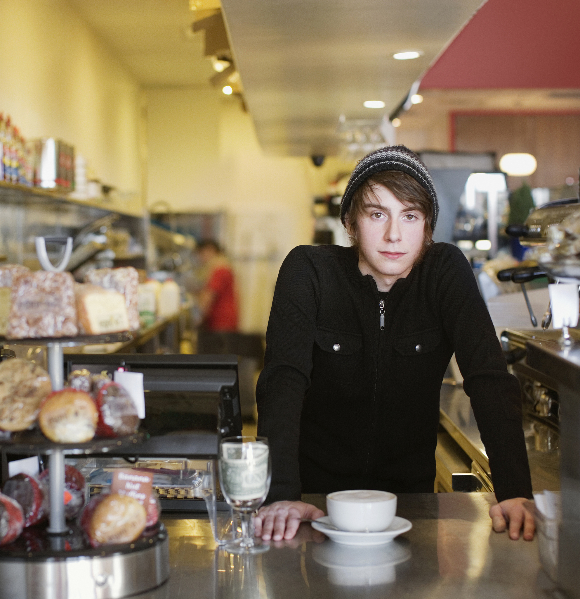 young man standing at counter in restaurant, portrait