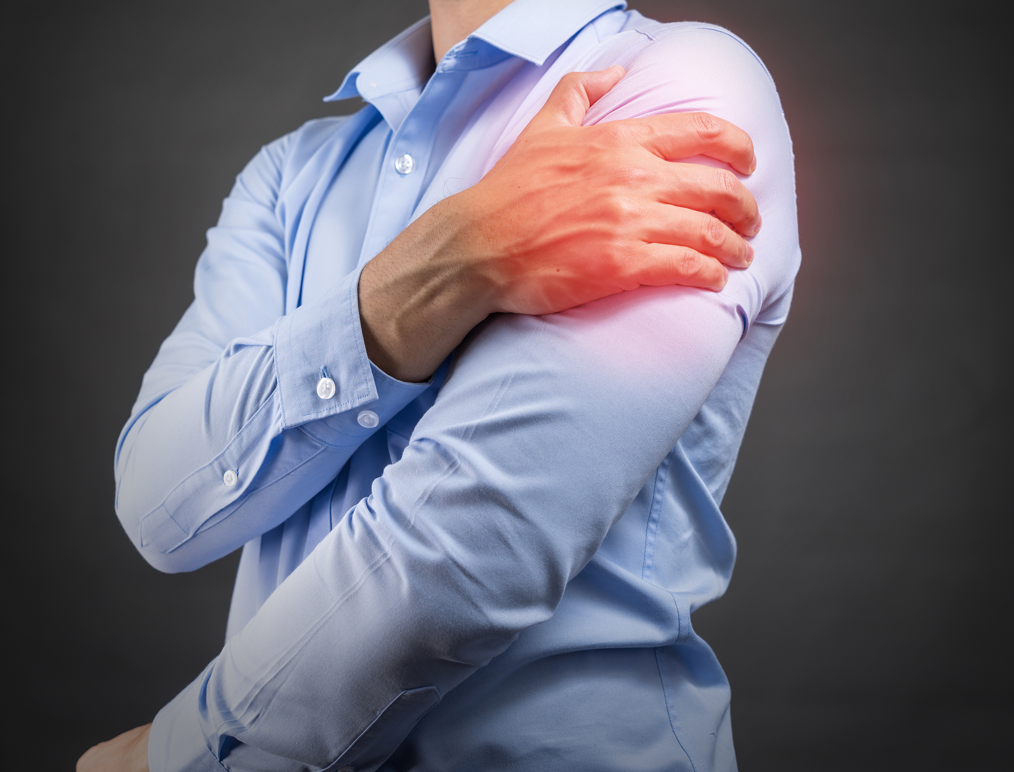 man holding his shoulder in pain