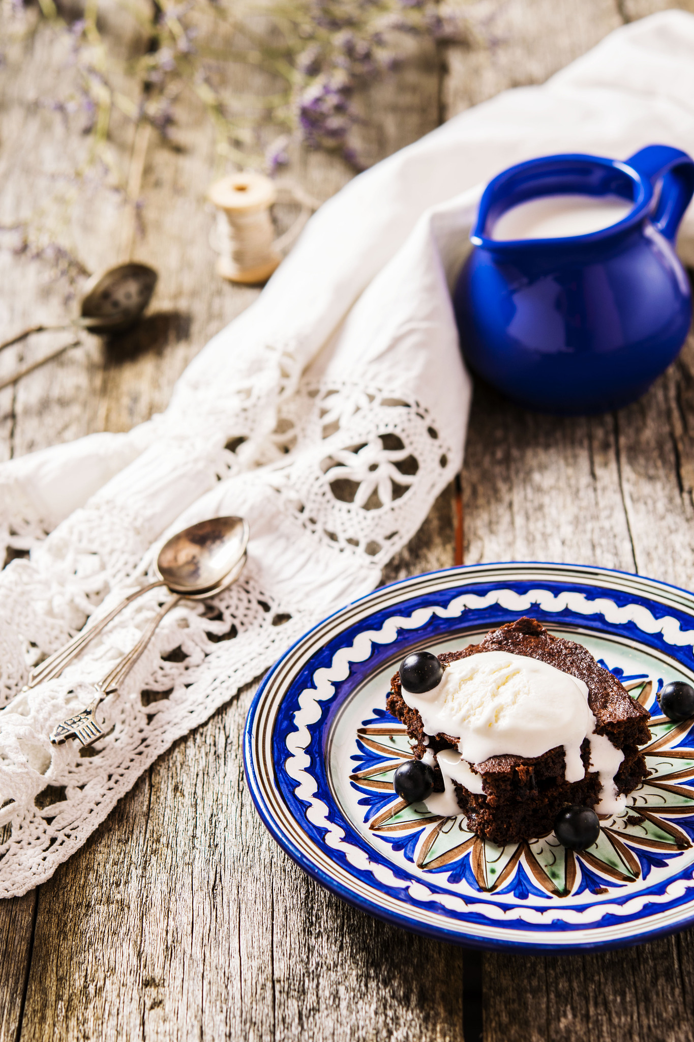 brownie with ice cream and a black currant