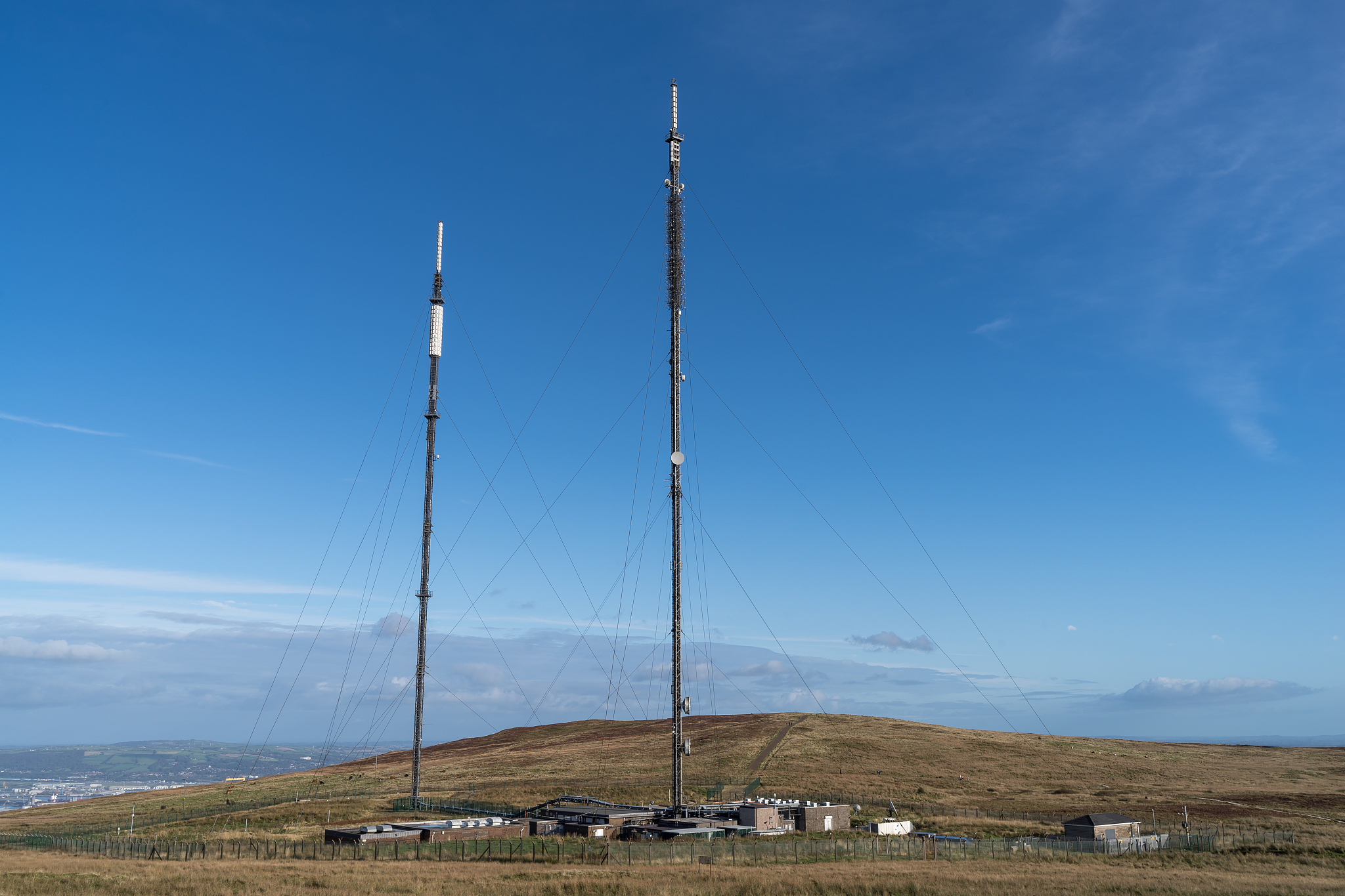 communications towers on a moor against a clear sky