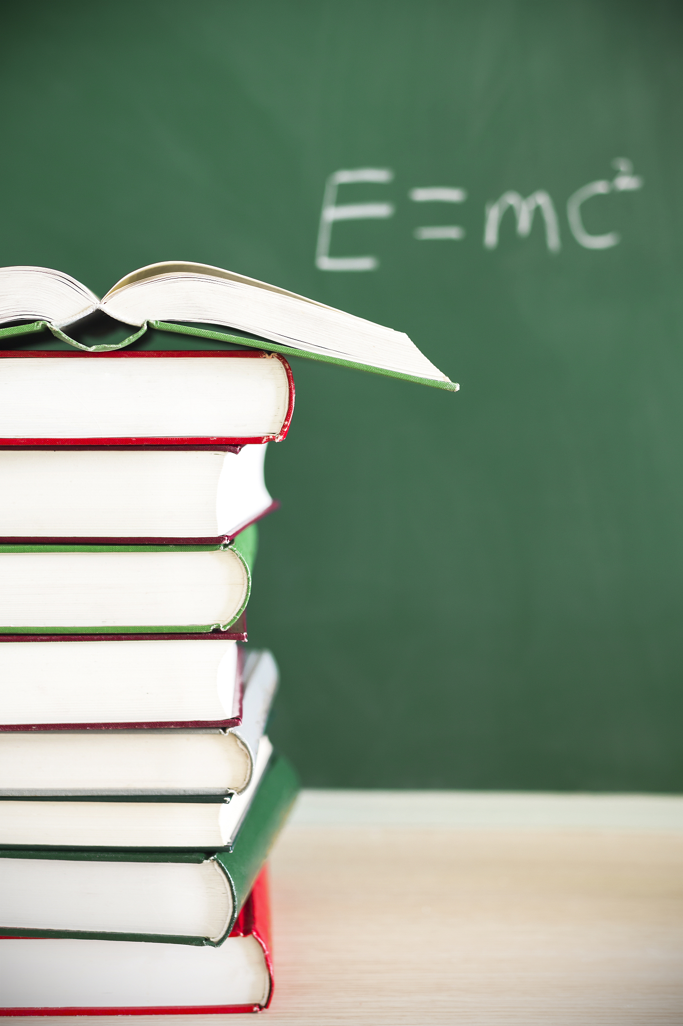 back to school:green apple sitting on education books