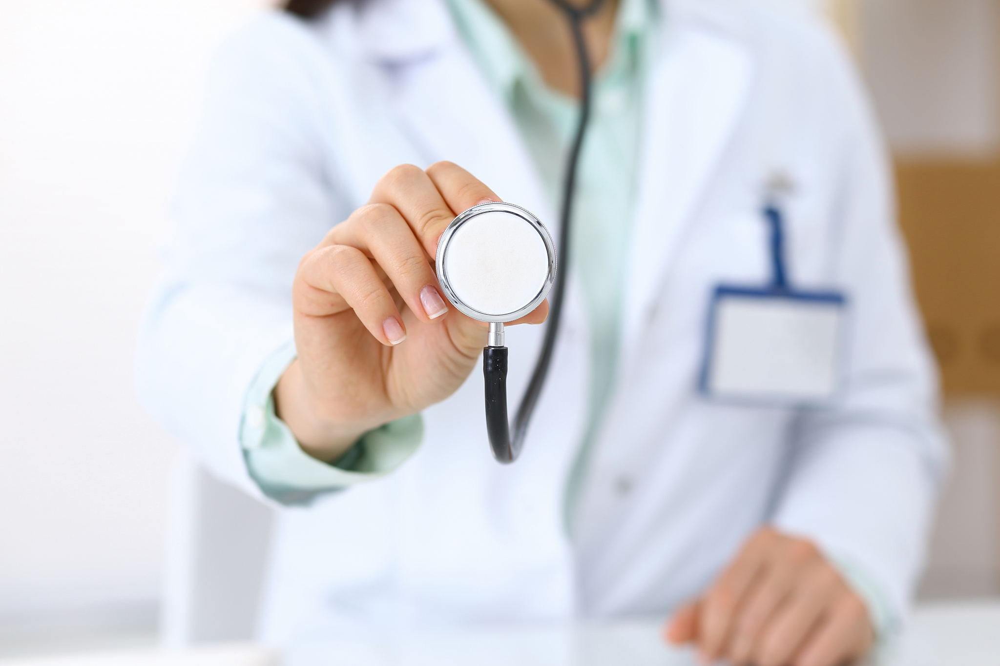 doctor holds stethoscope head, close-up. medical help and insura