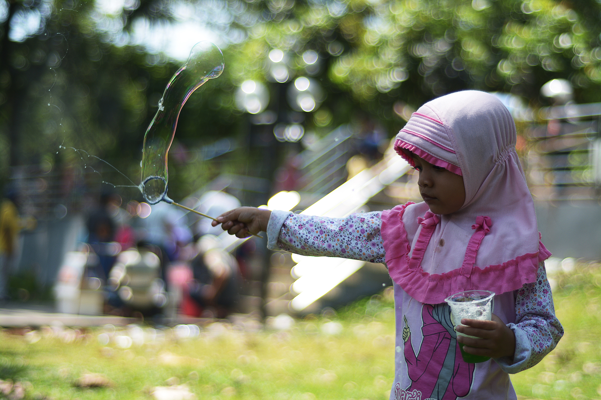 girl blowing bubbles outdoors