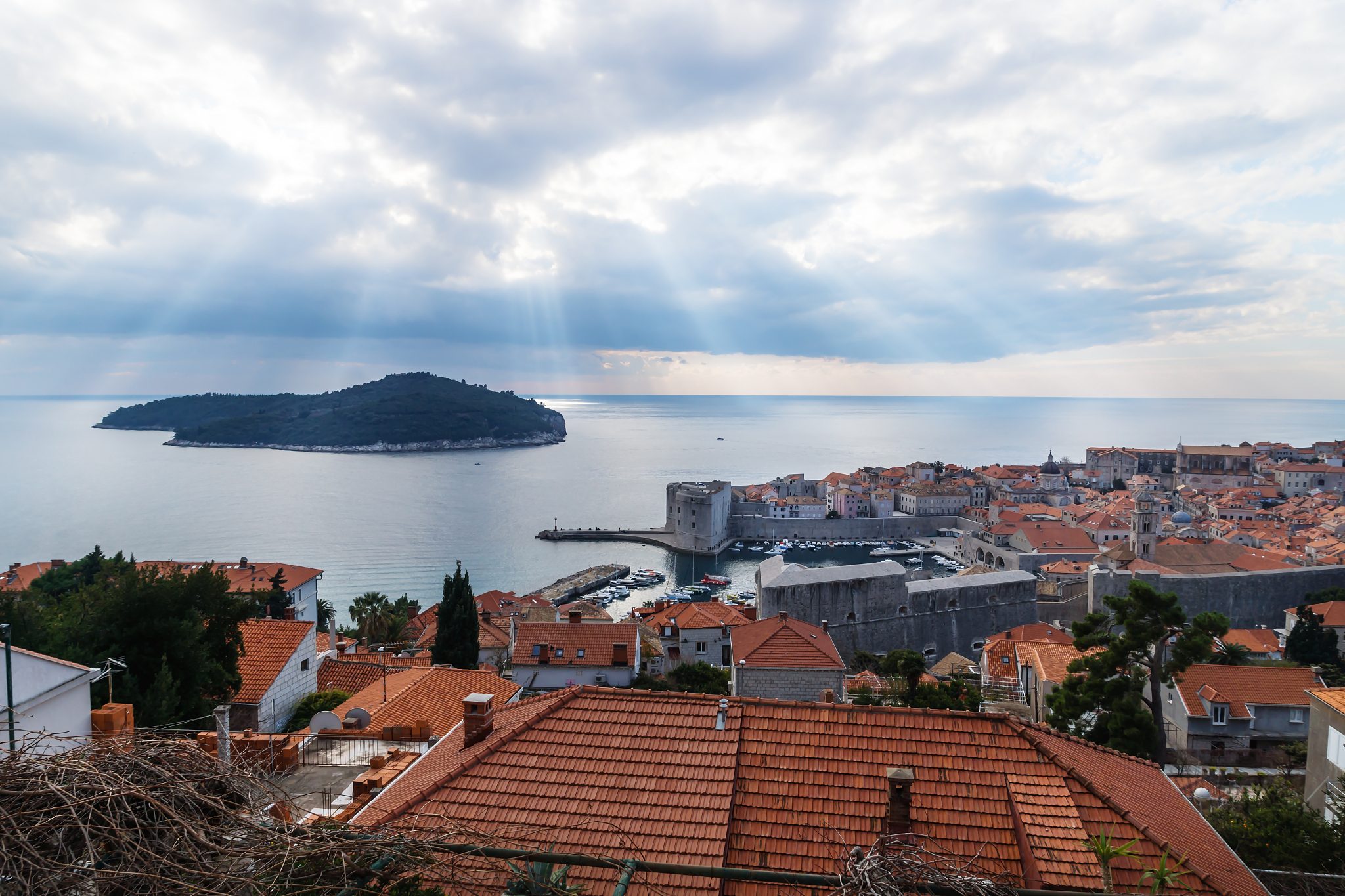 sunrays over lokrum island with aeriel view of dubrovnik, croati