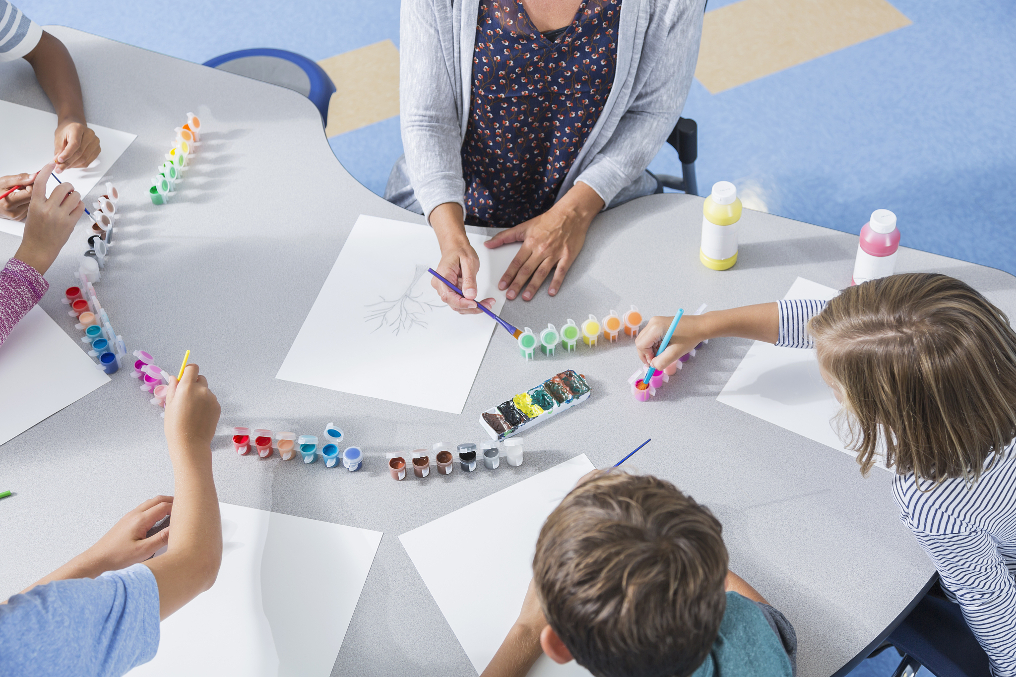 teacher and children in art class at school