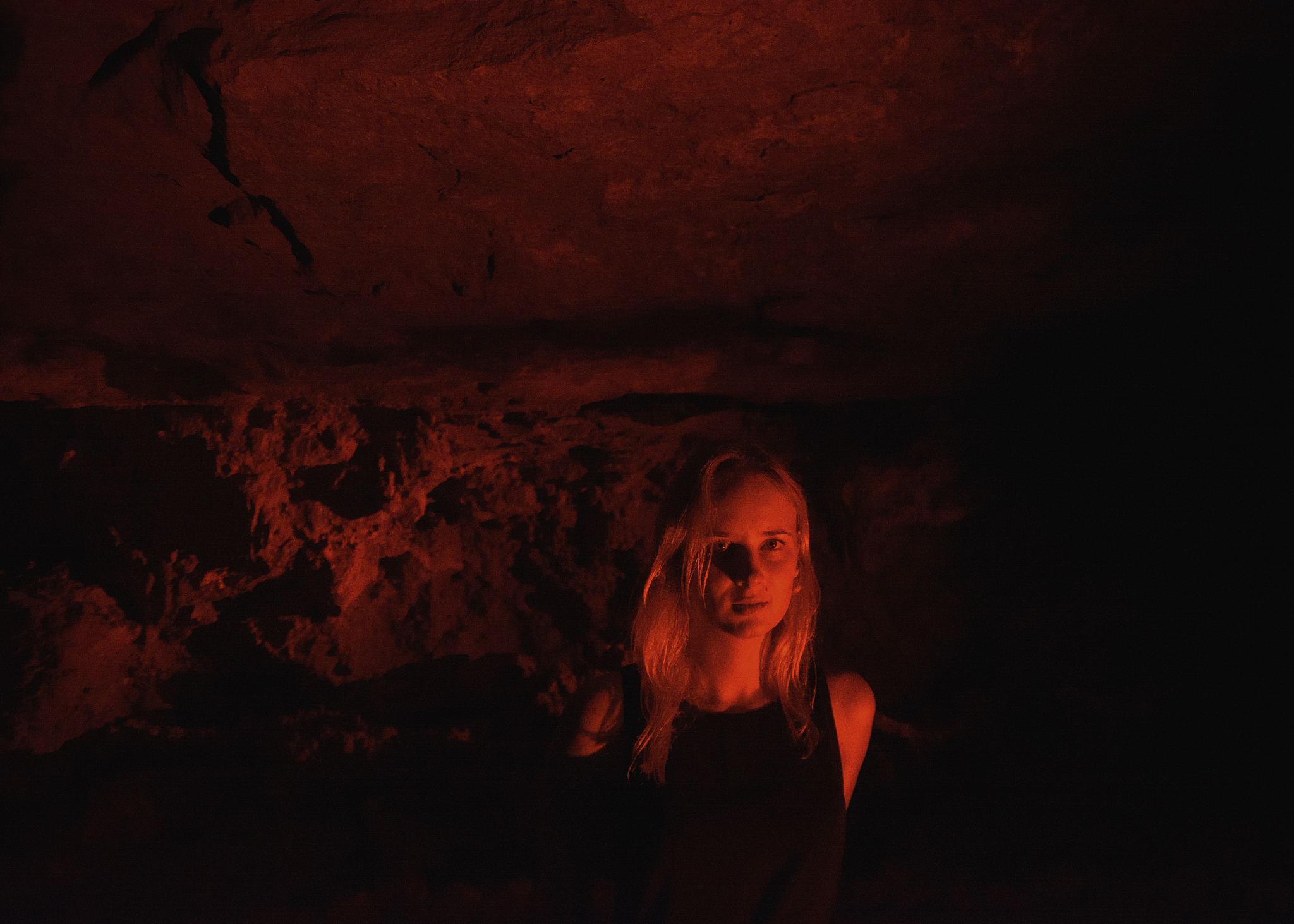 portrait of young woman in illuminated cave