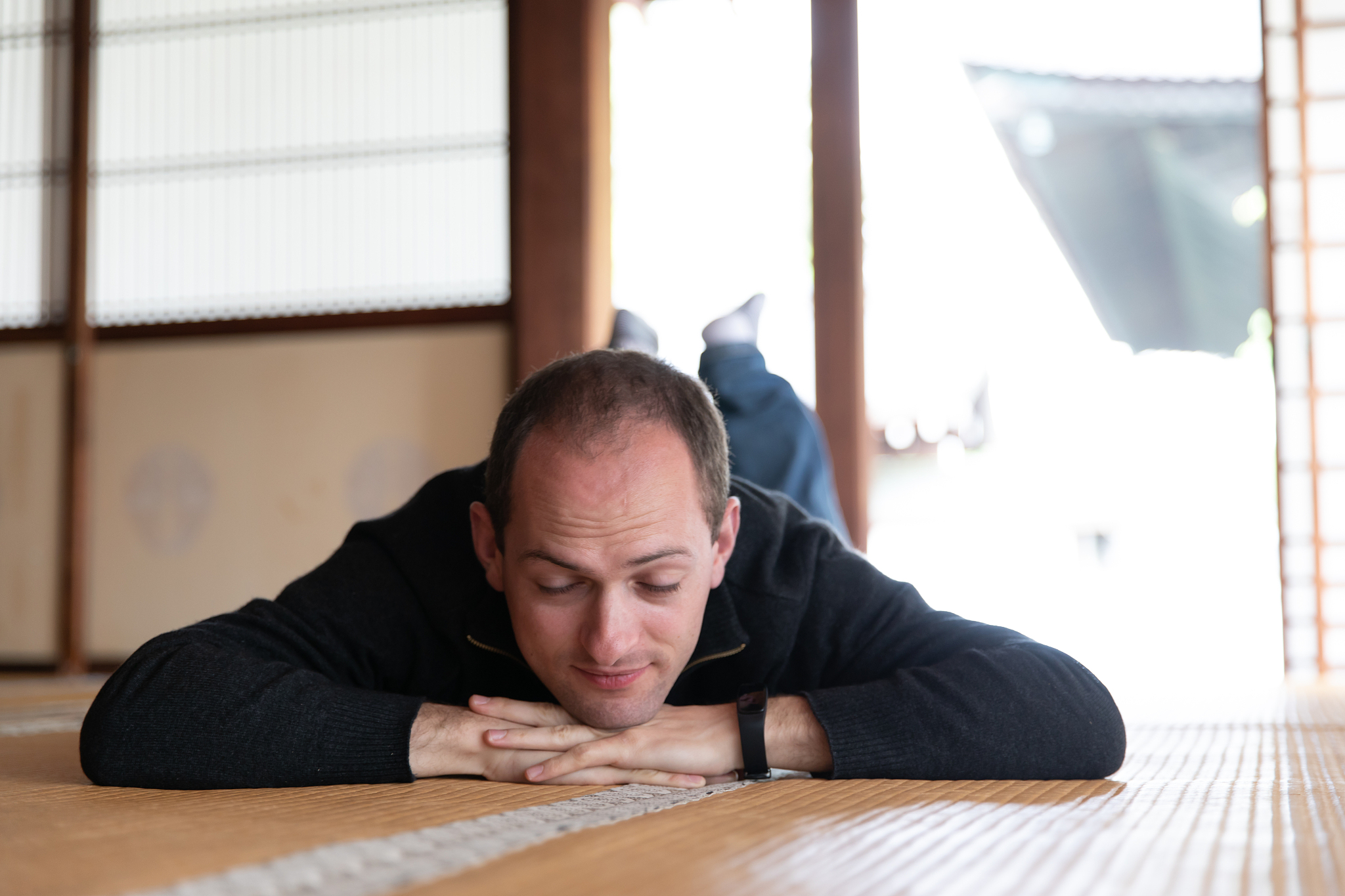 caucasian man lying down in japanese room
