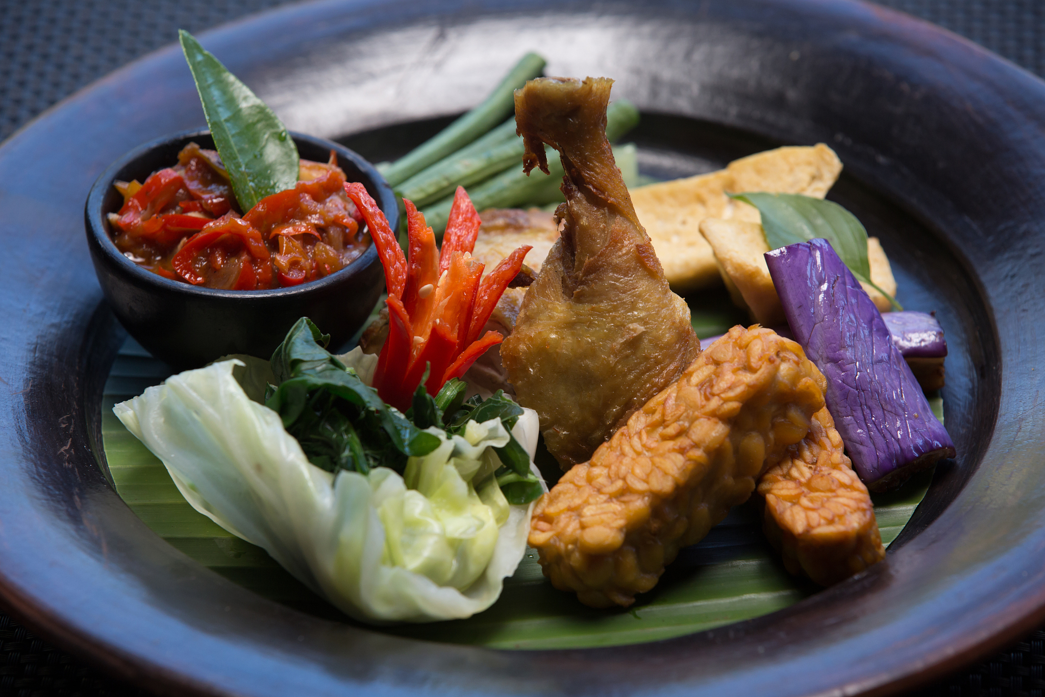 baked roasted fried chicken drumstick with vegetables and hot sa