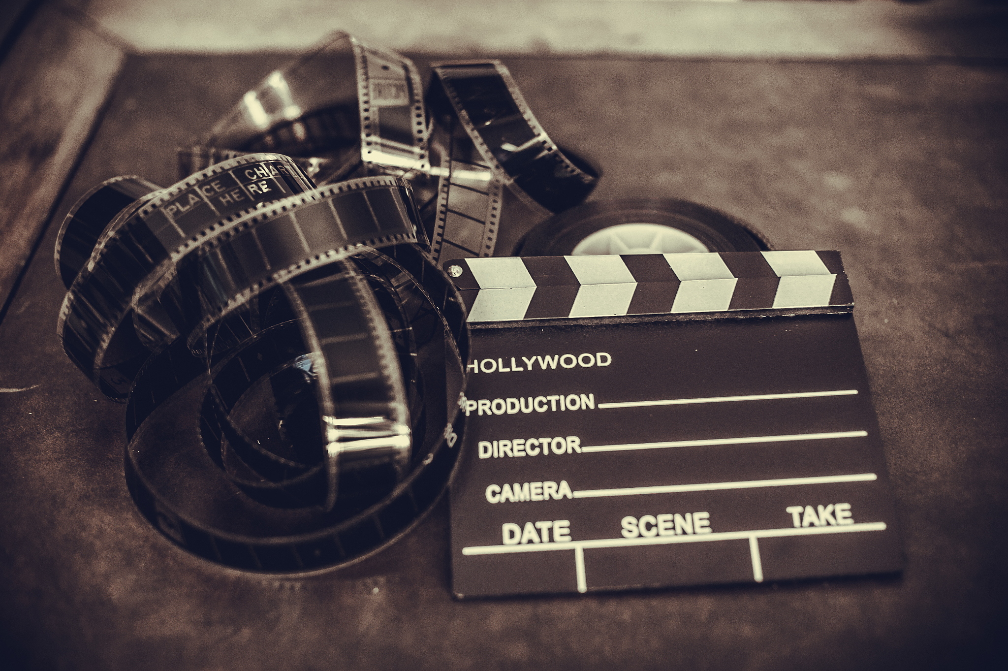 movie clapper board and filmstrip selective focus