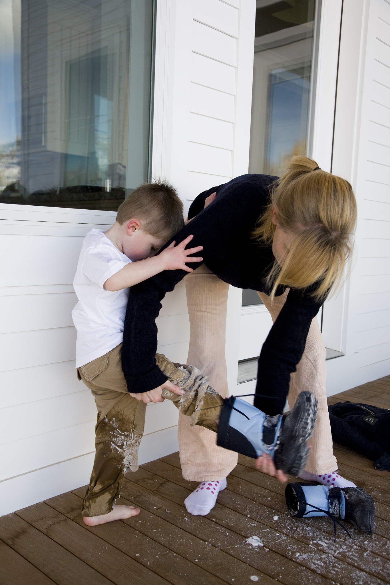 mother and child taking off boots