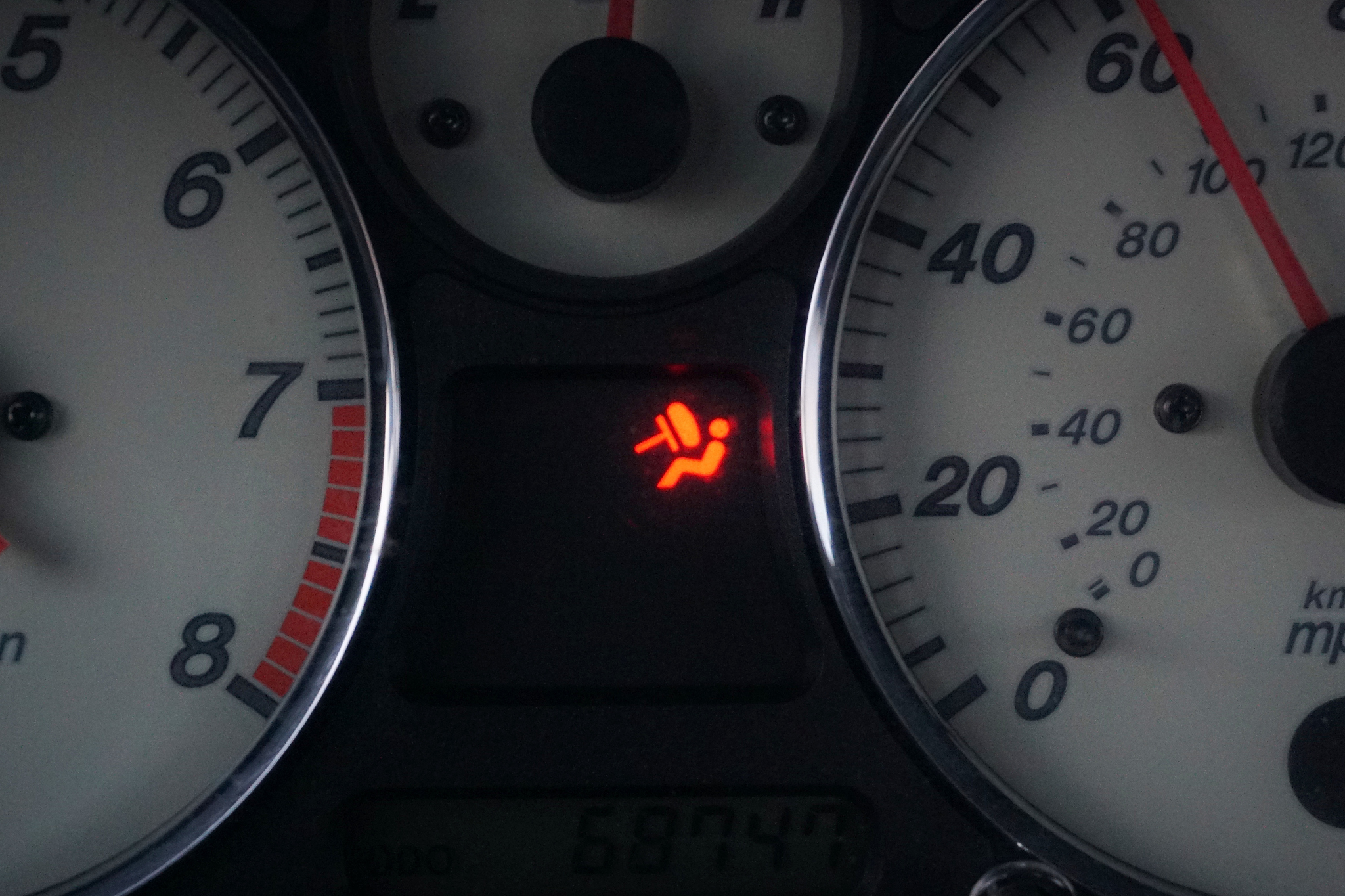 illuminated check airbag light displayed on a vehicle dashboard