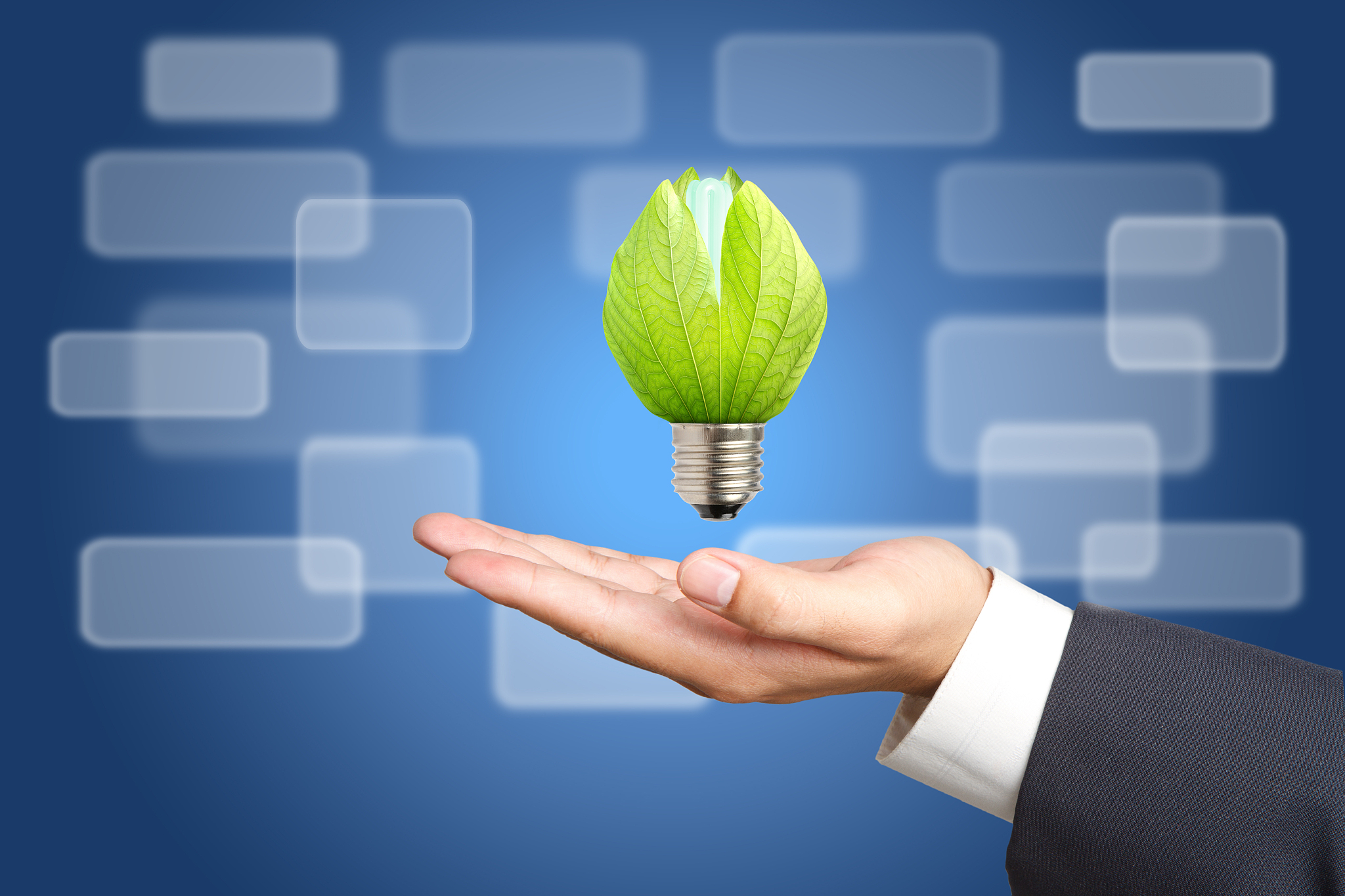 concept of energy saving light bulbs on business hand