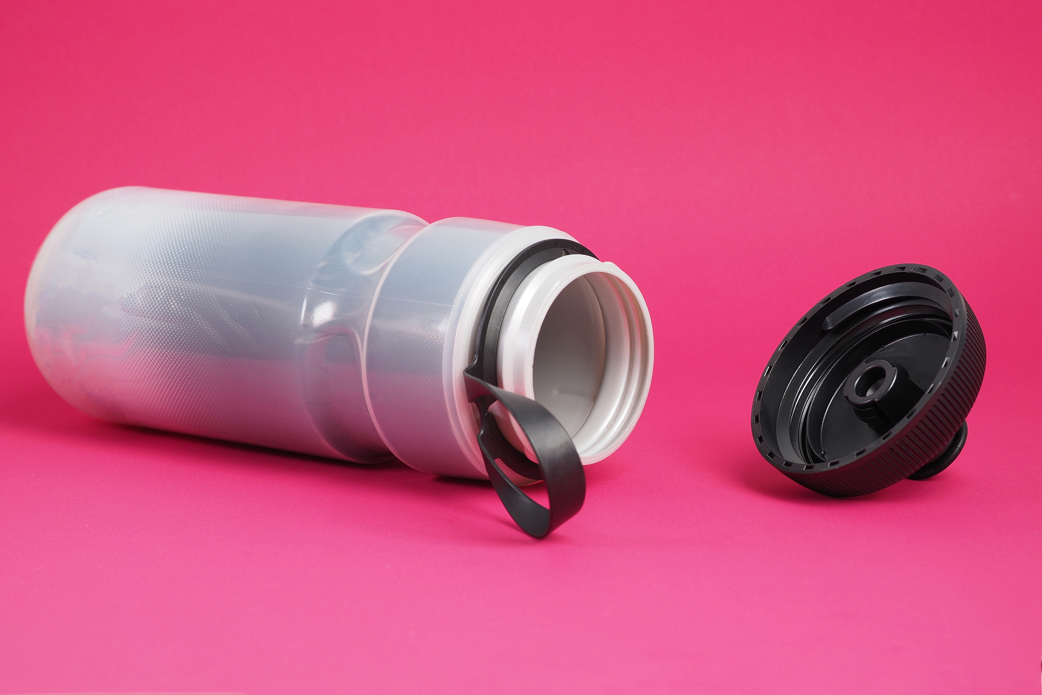 gray insulated plastic sport bottle with open cap for cycling on