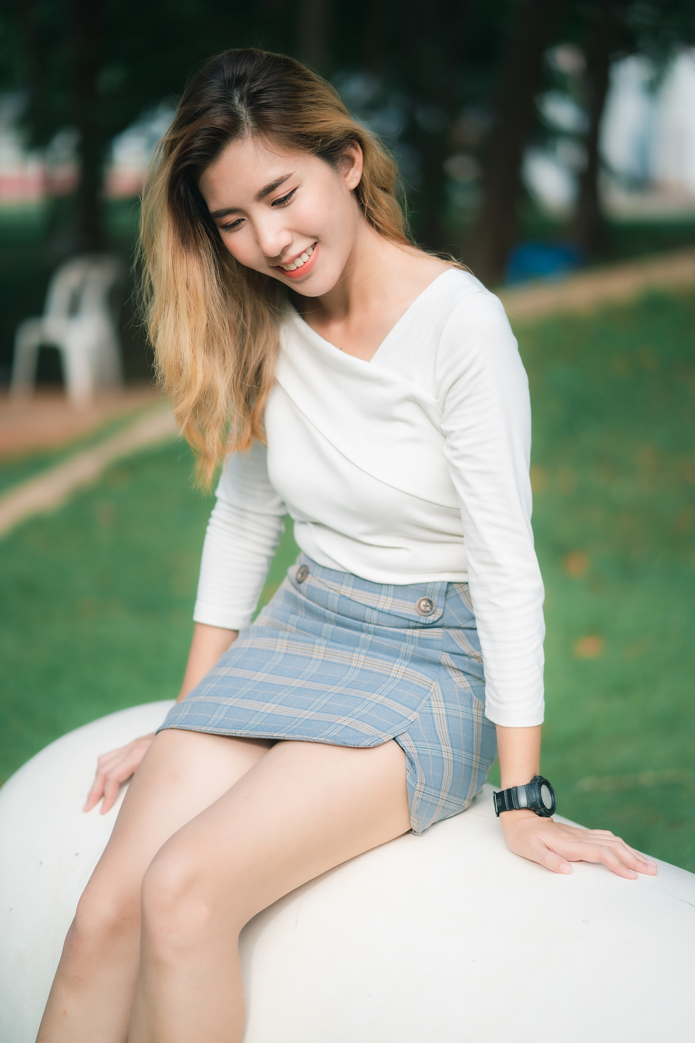 beautiful young woman sitting outdoors