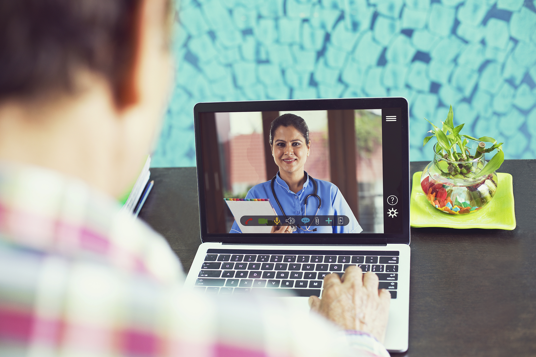 sick man video conferencing with doctors using laptop