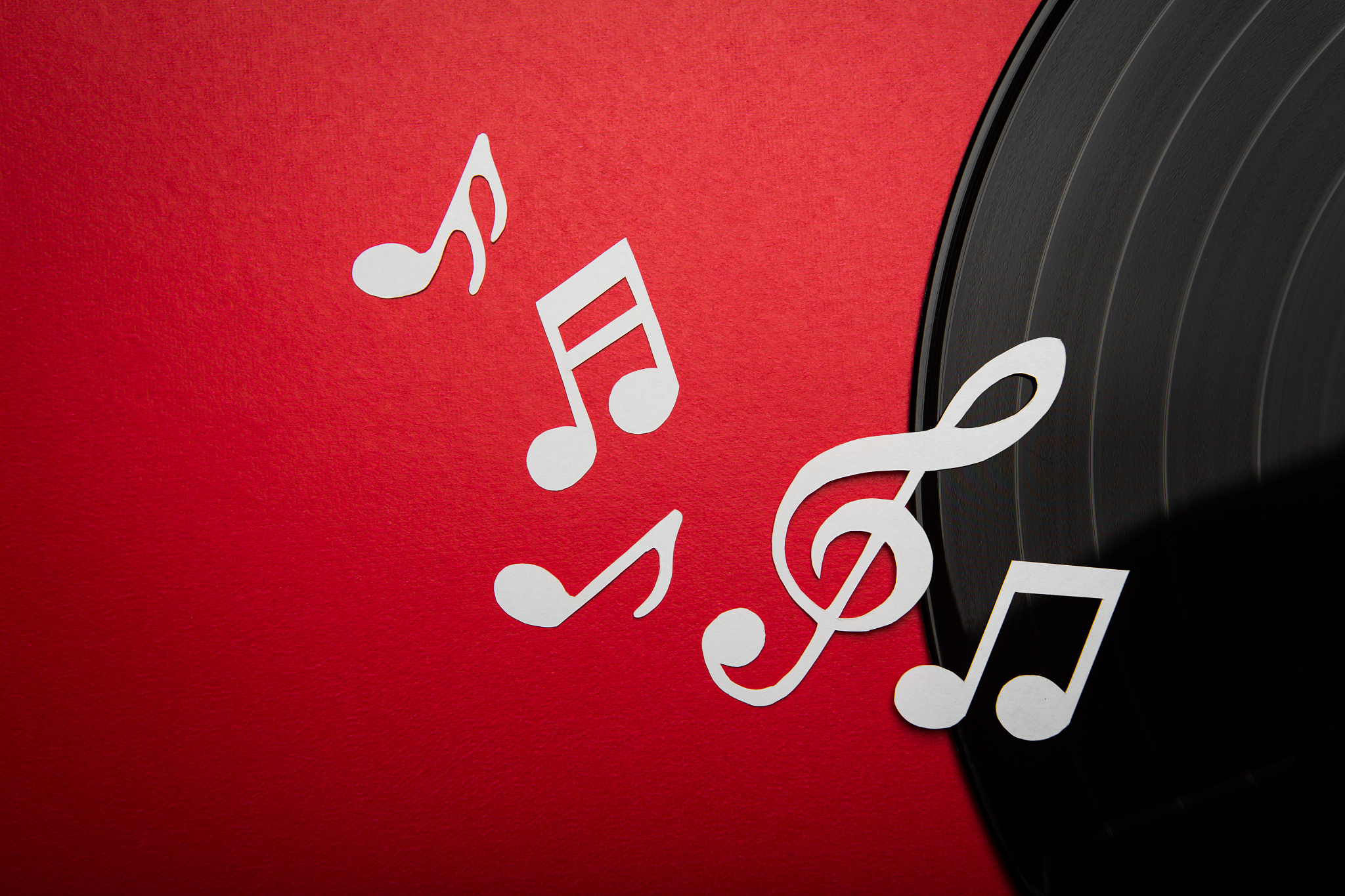 paper cut of music note on black vinyl record