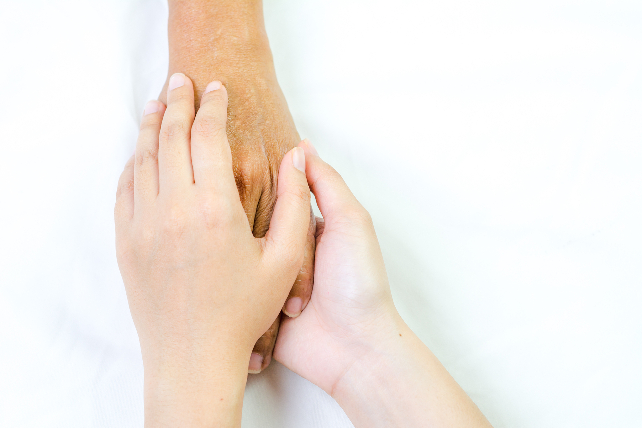 asian senior and asian young holding hands.