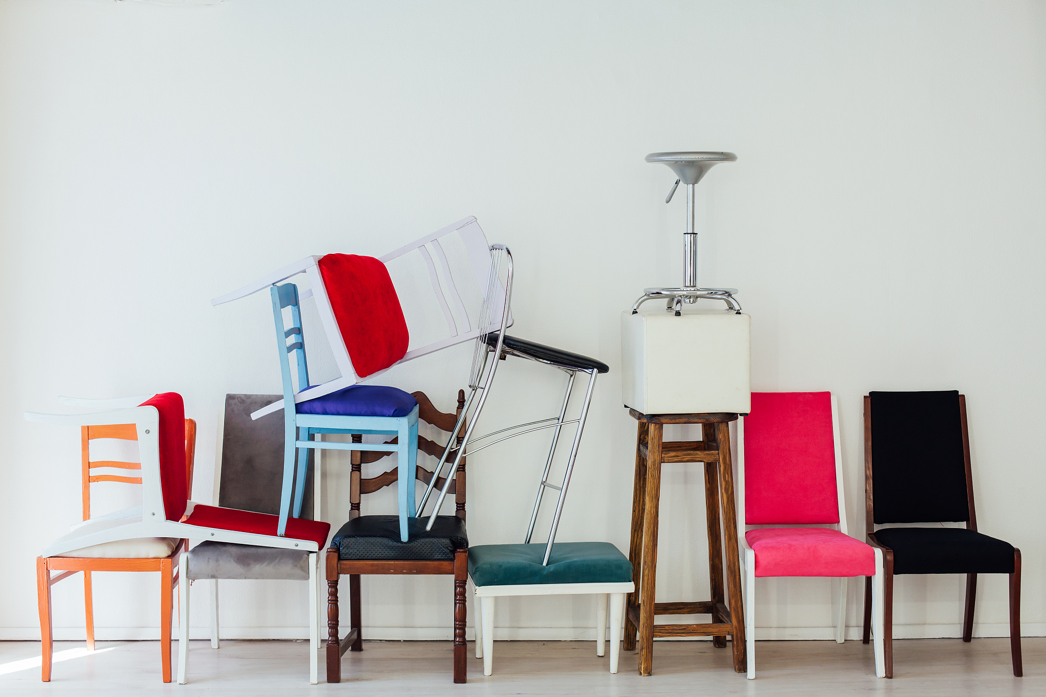 lots of multicolored chairs in the interior of the white room