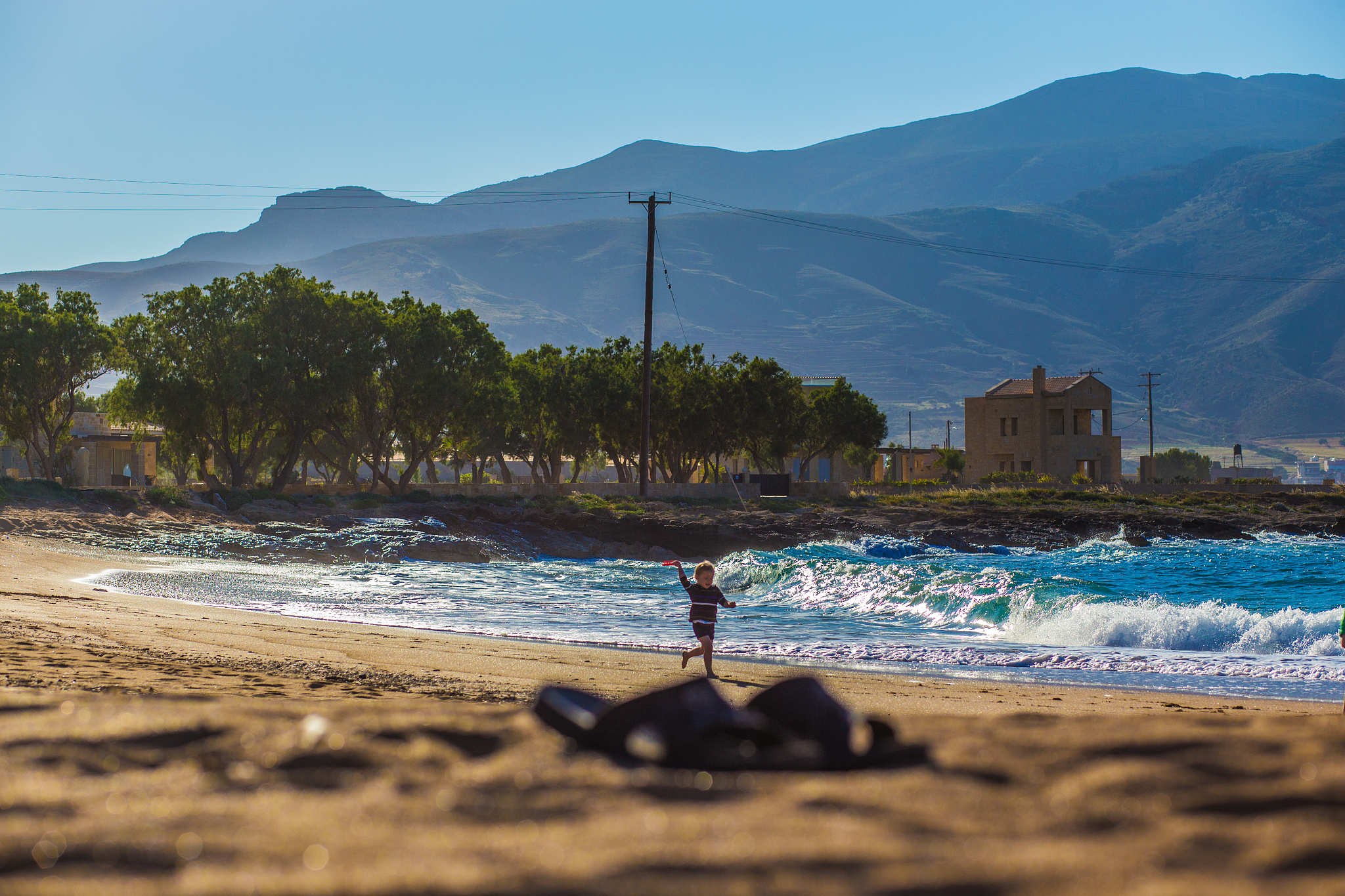 boy runs on beach.