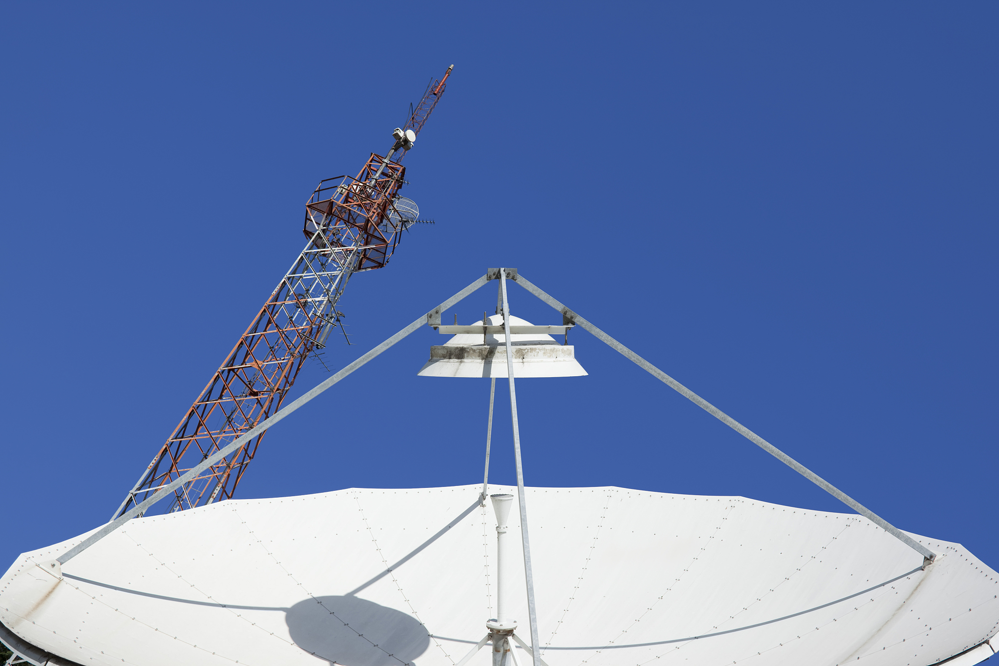 blue sky over satellite dish and radio mast