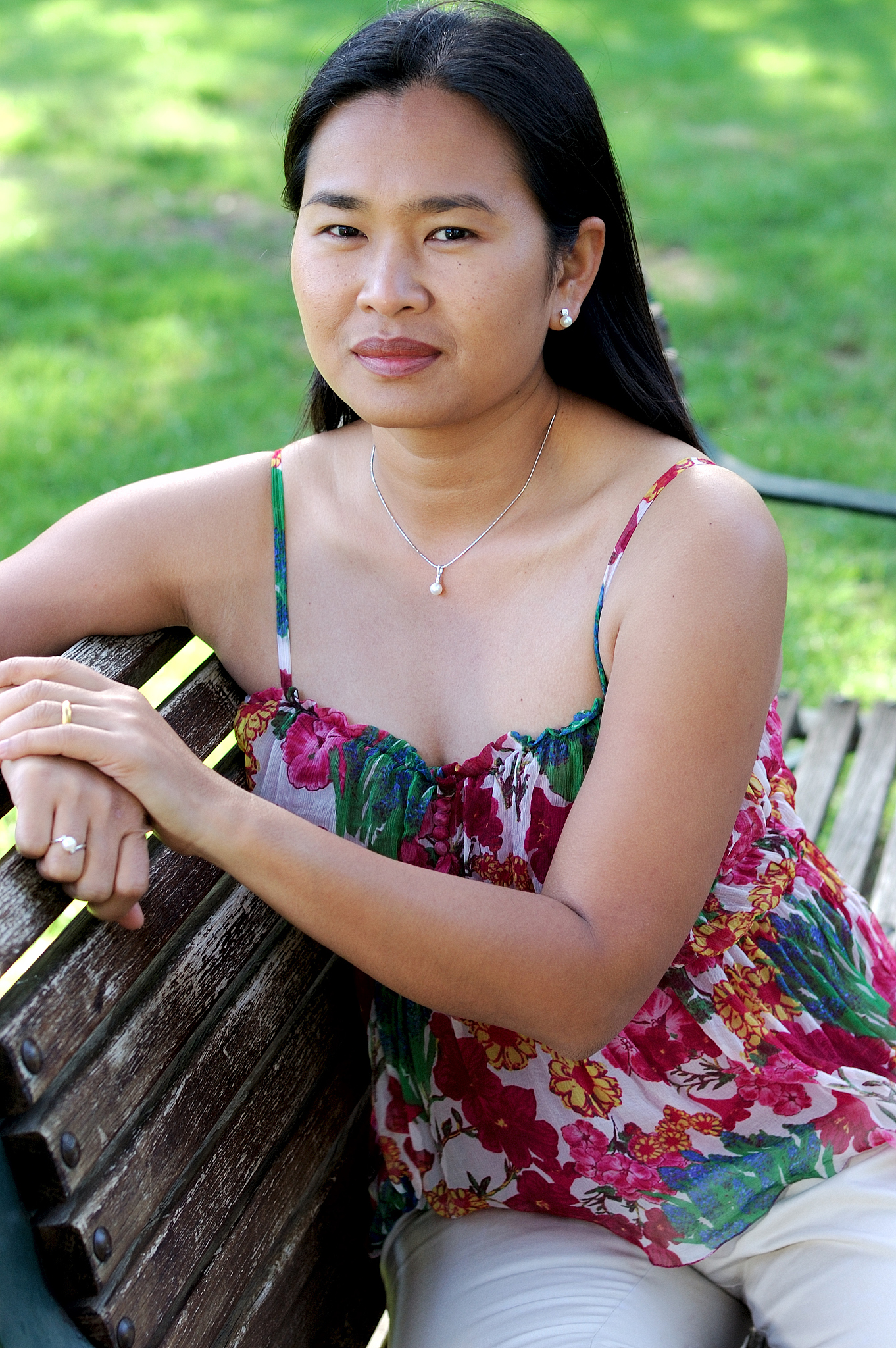 asian woman sitting on a bench
