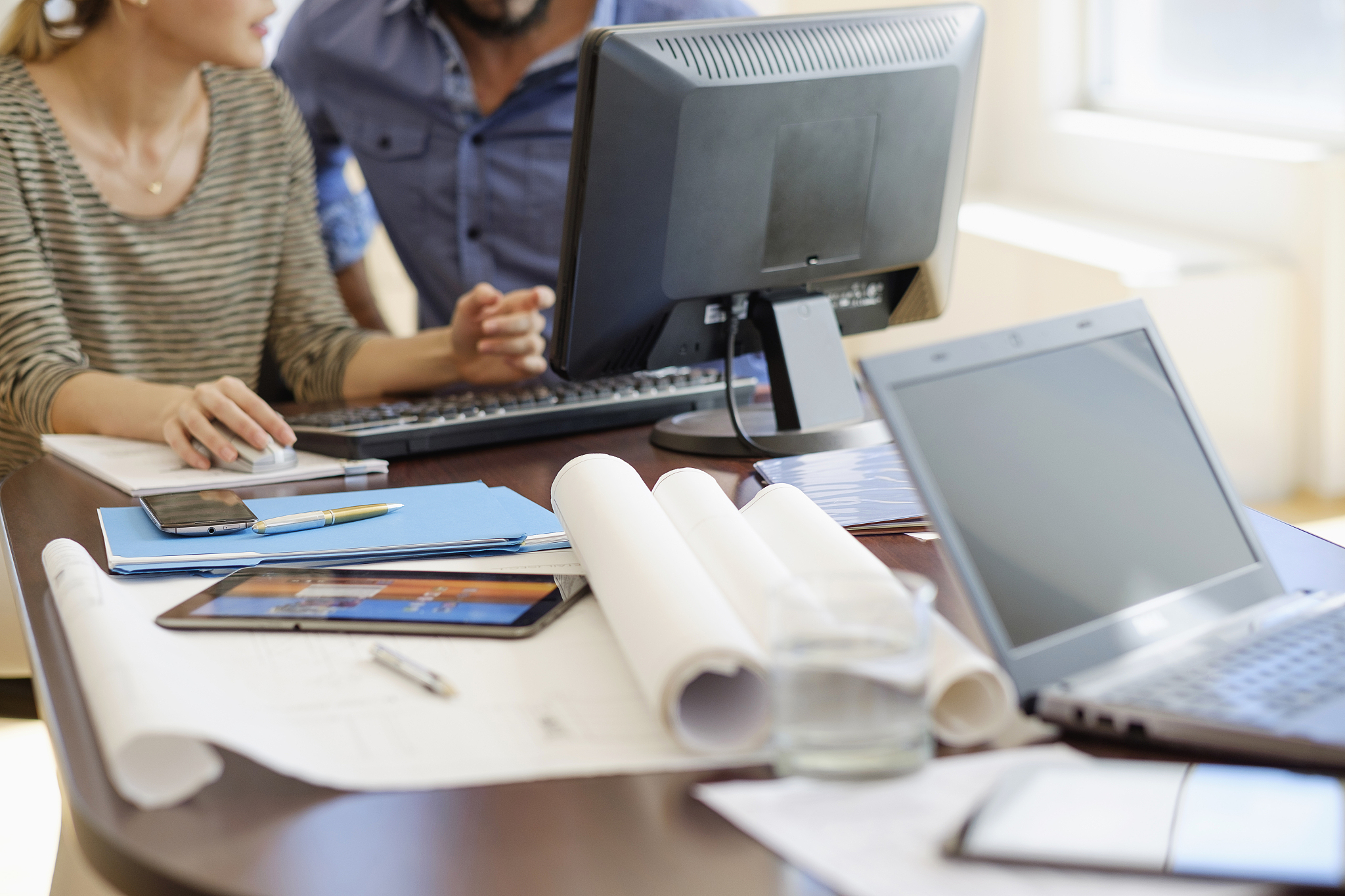 man and woman working in office