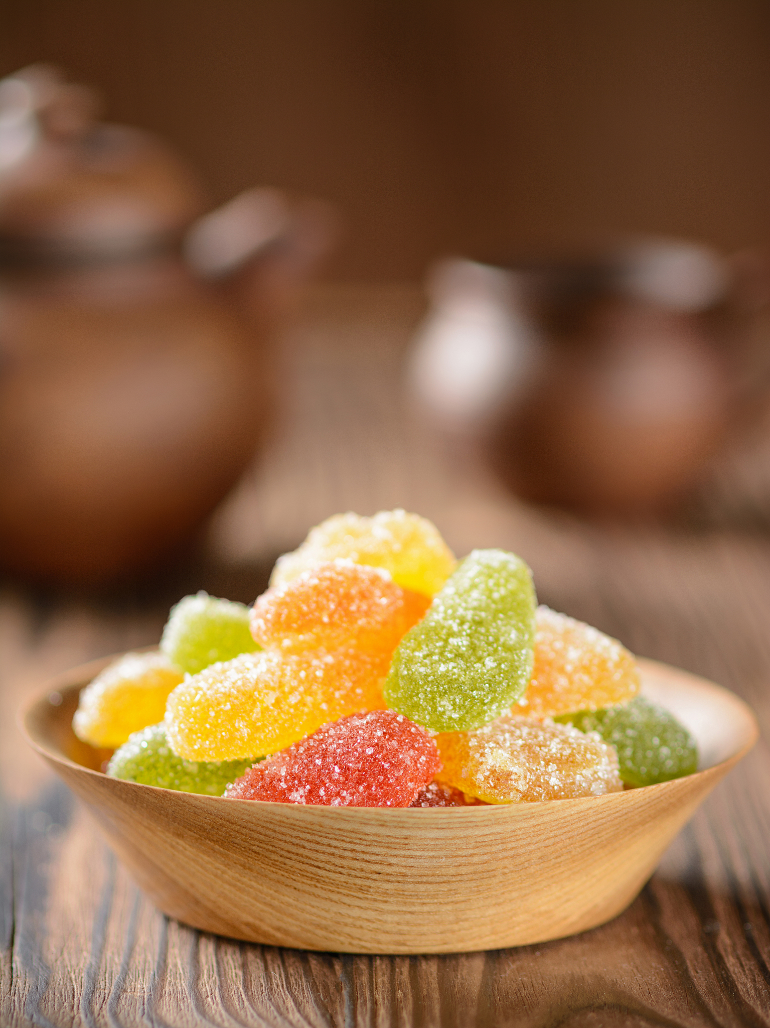 marmalade in a wooden plate on a wooden table with a kettle and 