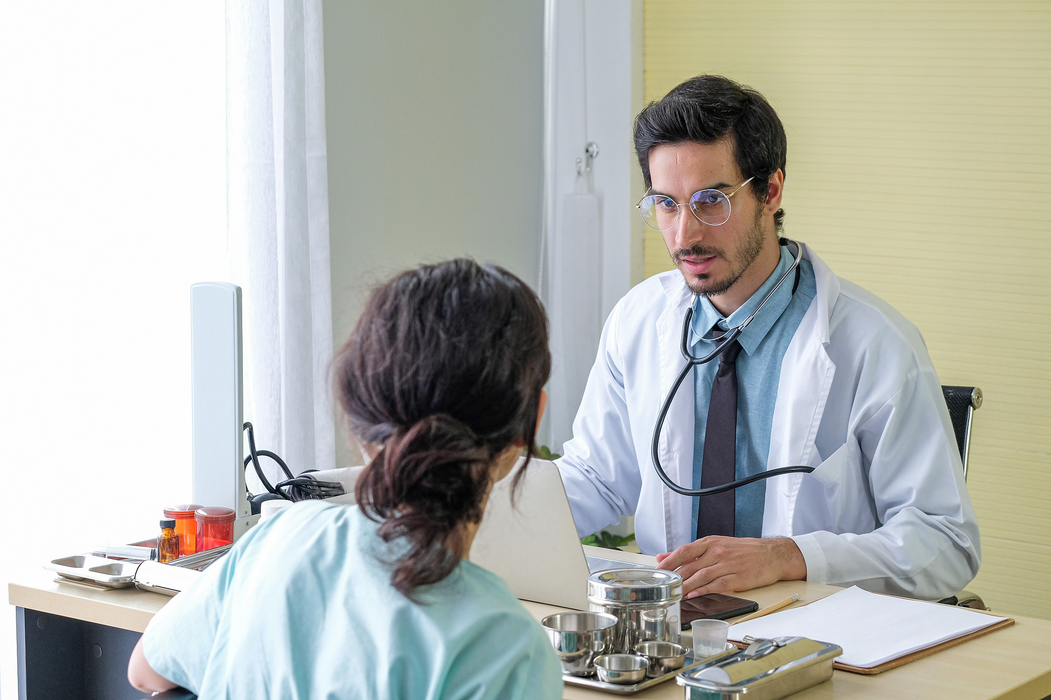 doctor talking with patient in hospital