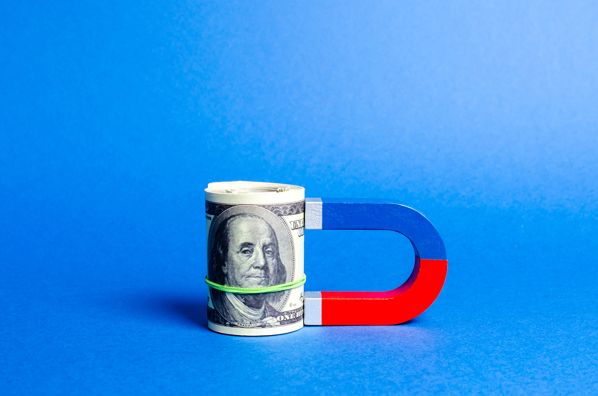 the magnet is magnetized to dollars bundle. attracting money and