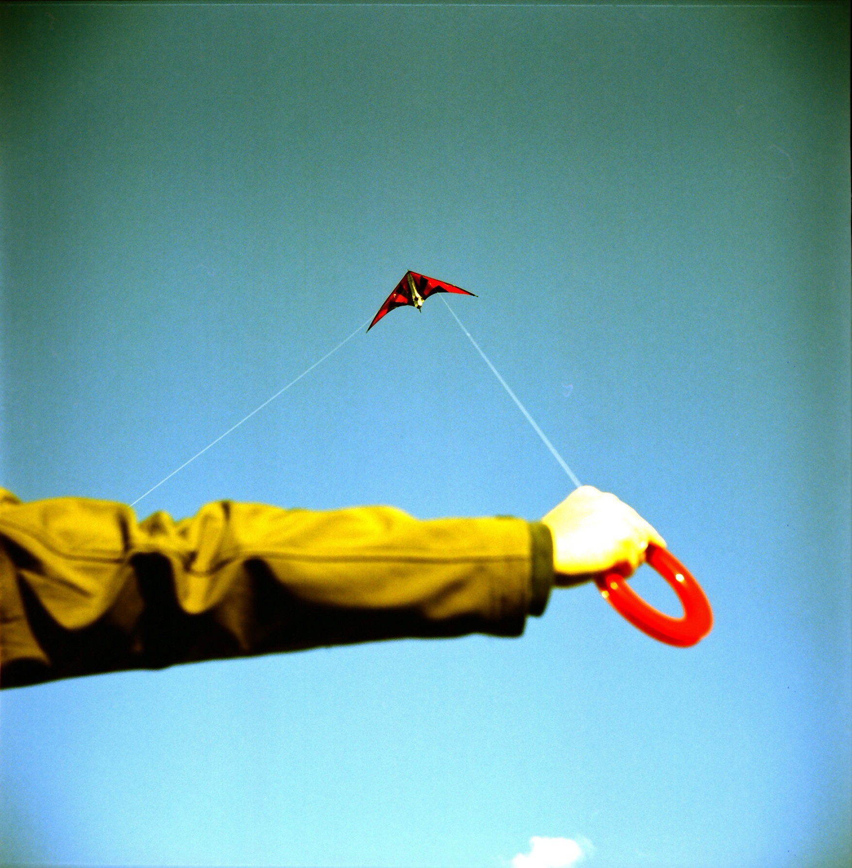 cropped boy flying kite against clear sky