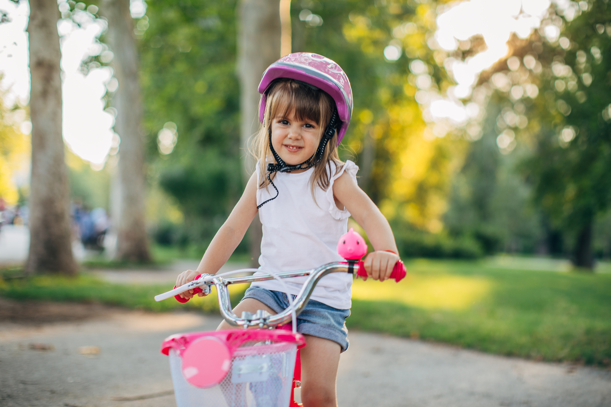 little girl learning to drive a bike