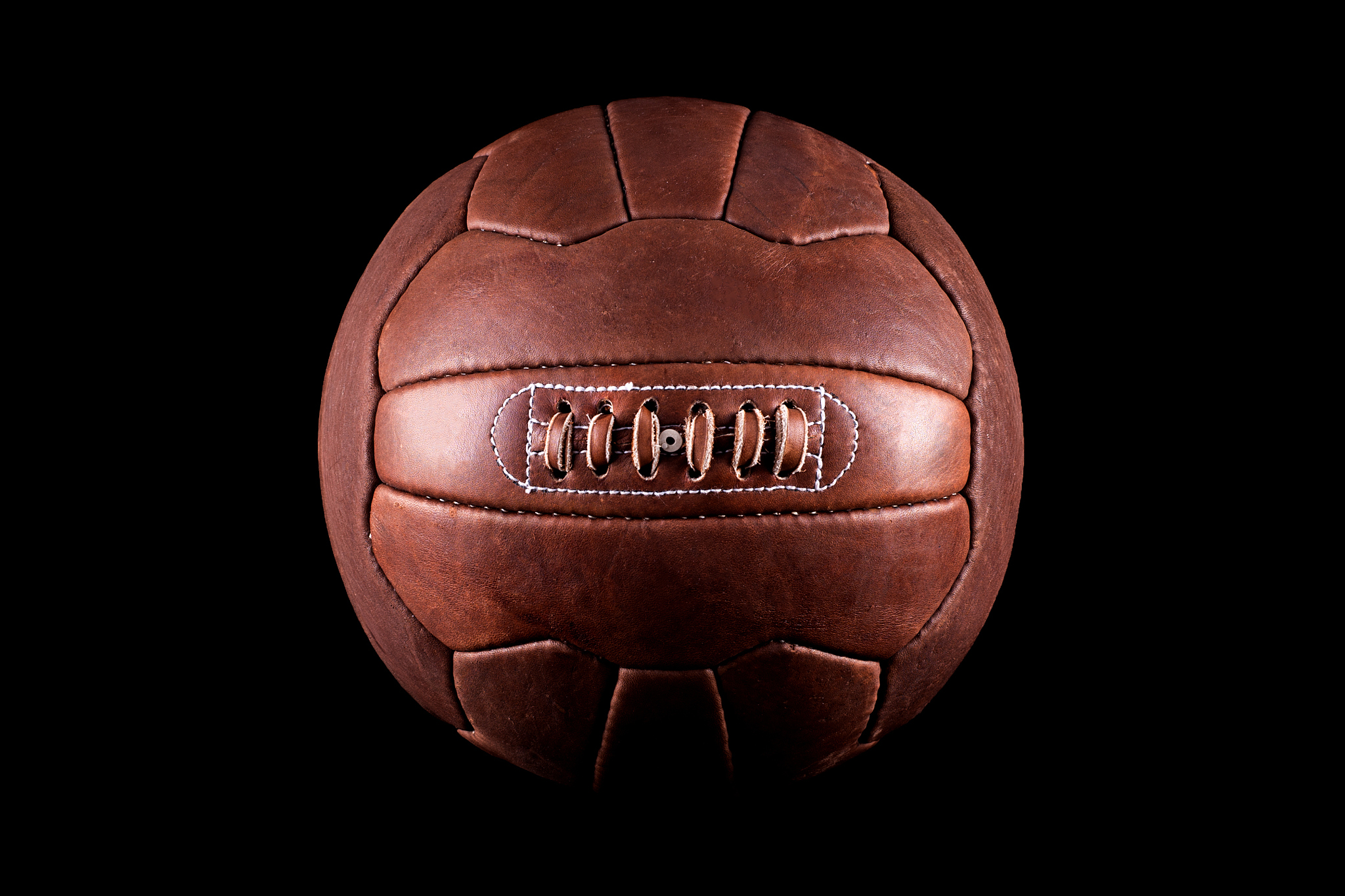 old football leather ball on a black background