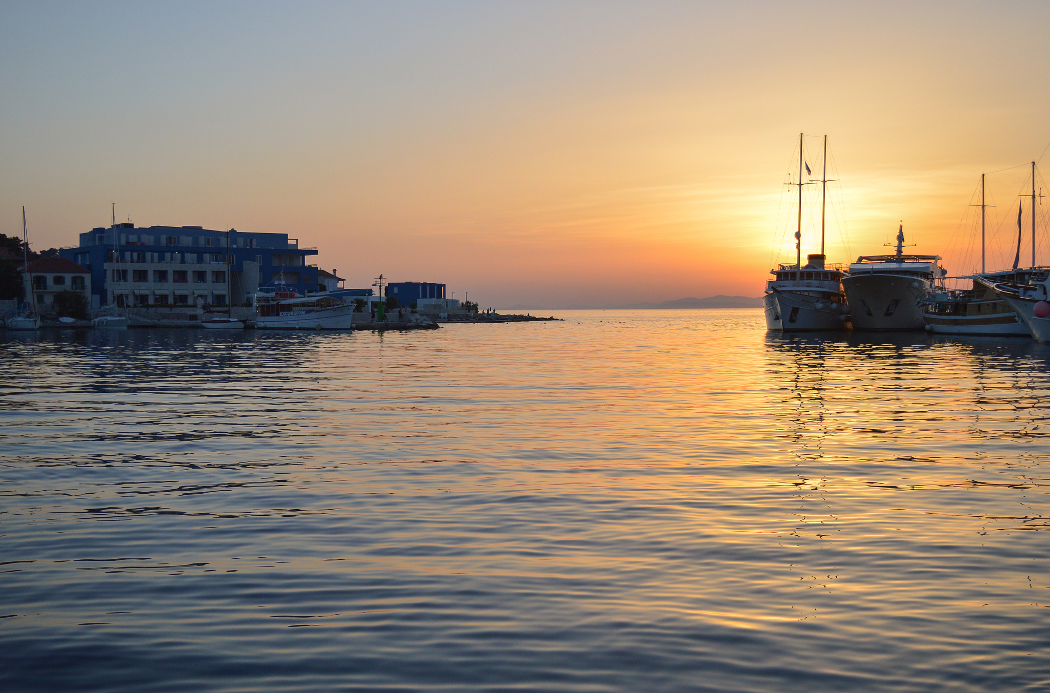 postira harbor on brac island at sunset