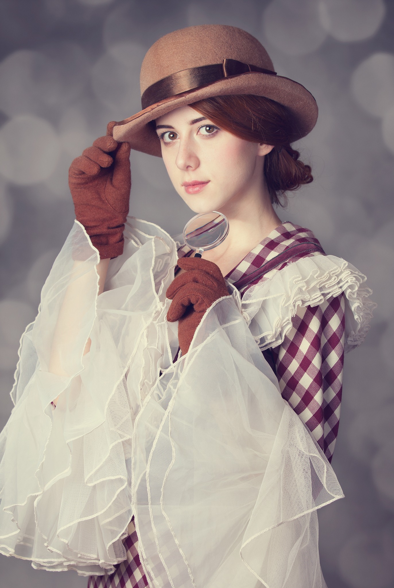 beautiful redhead women with magnifying glass.