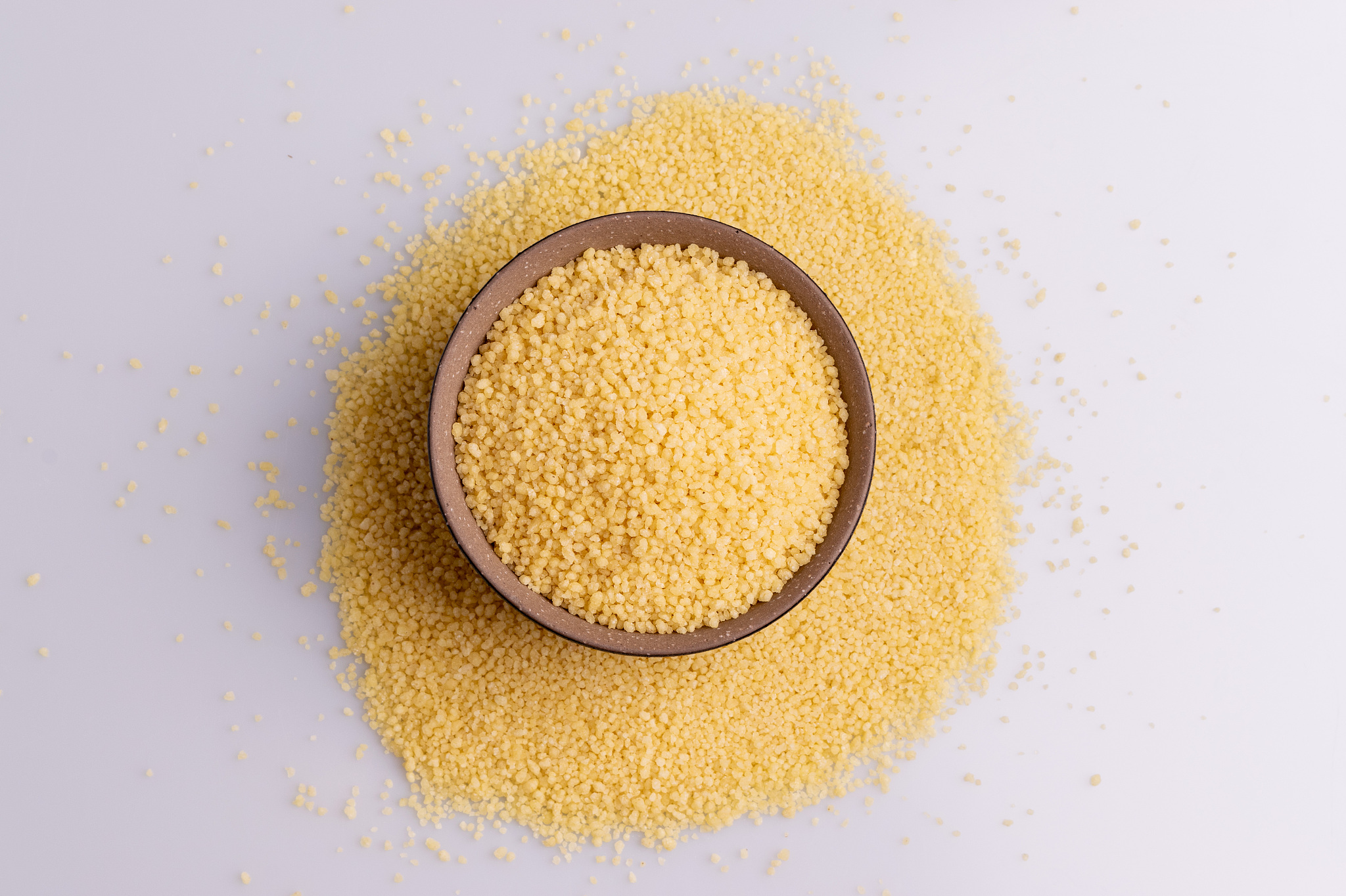 dry couscous isolated on white background, soft light, copy spac