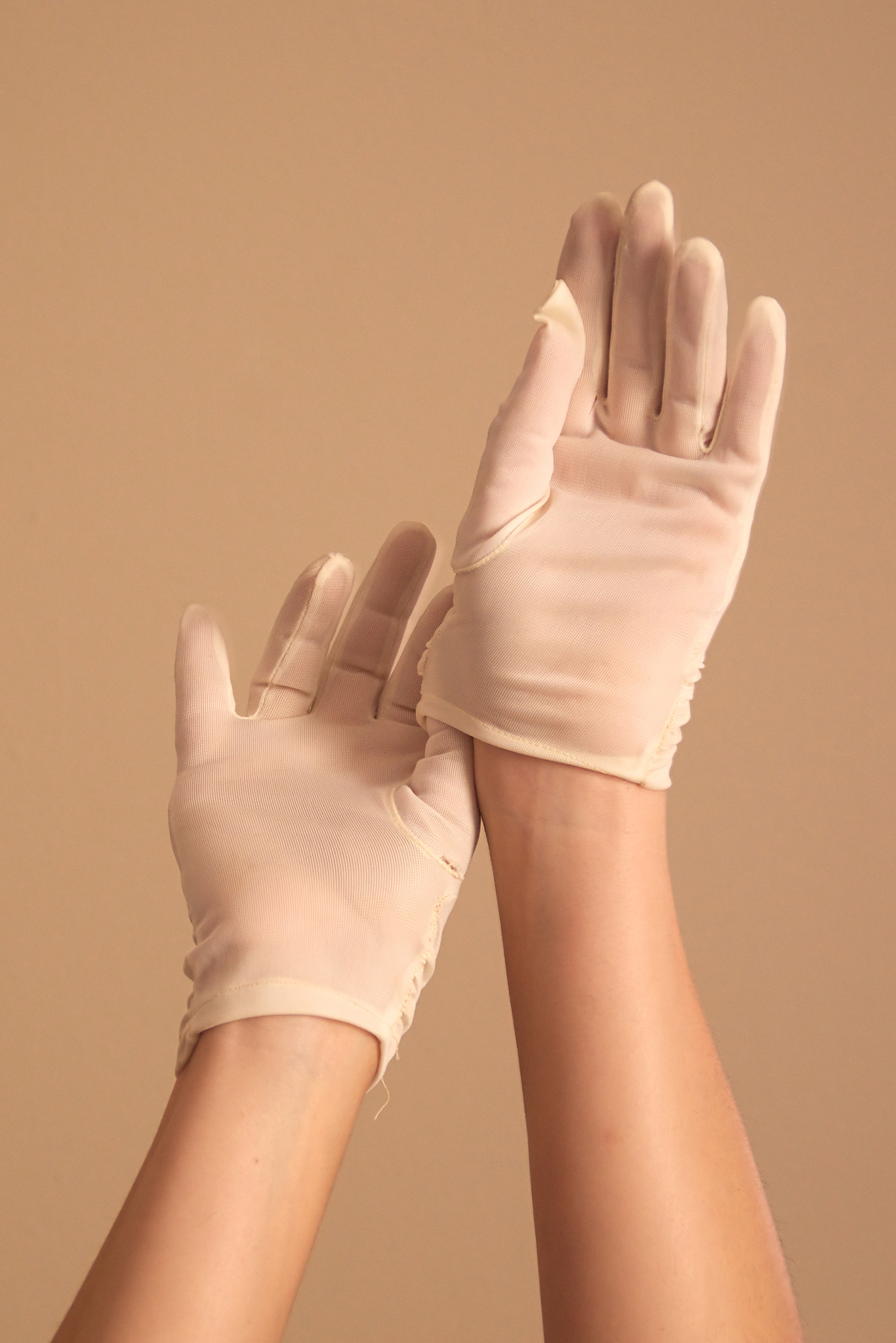 woman adjusting vintage white gloves