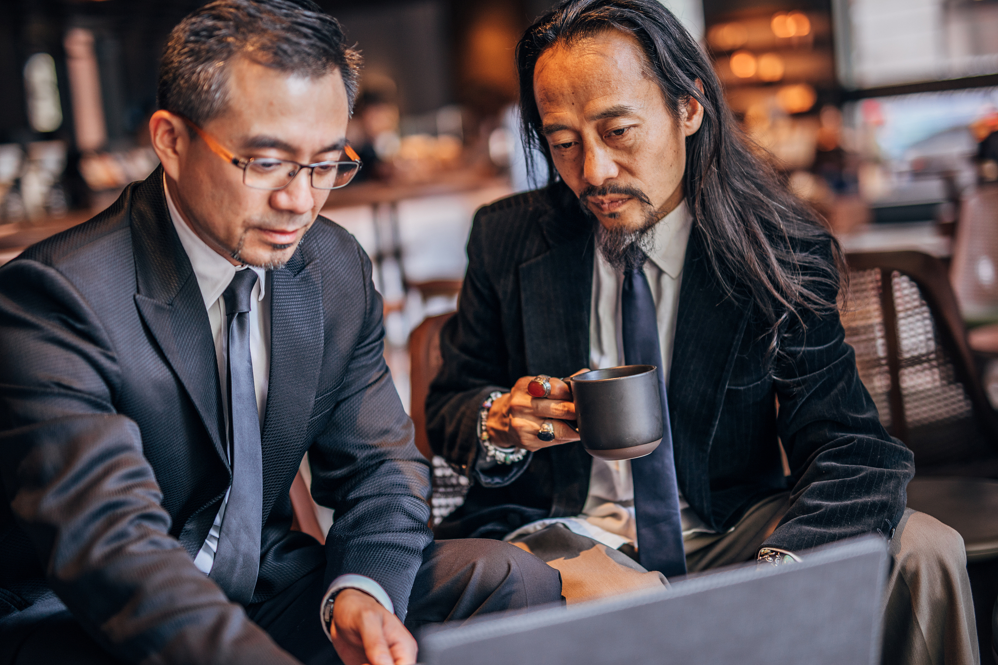 two asian businessman in cafe