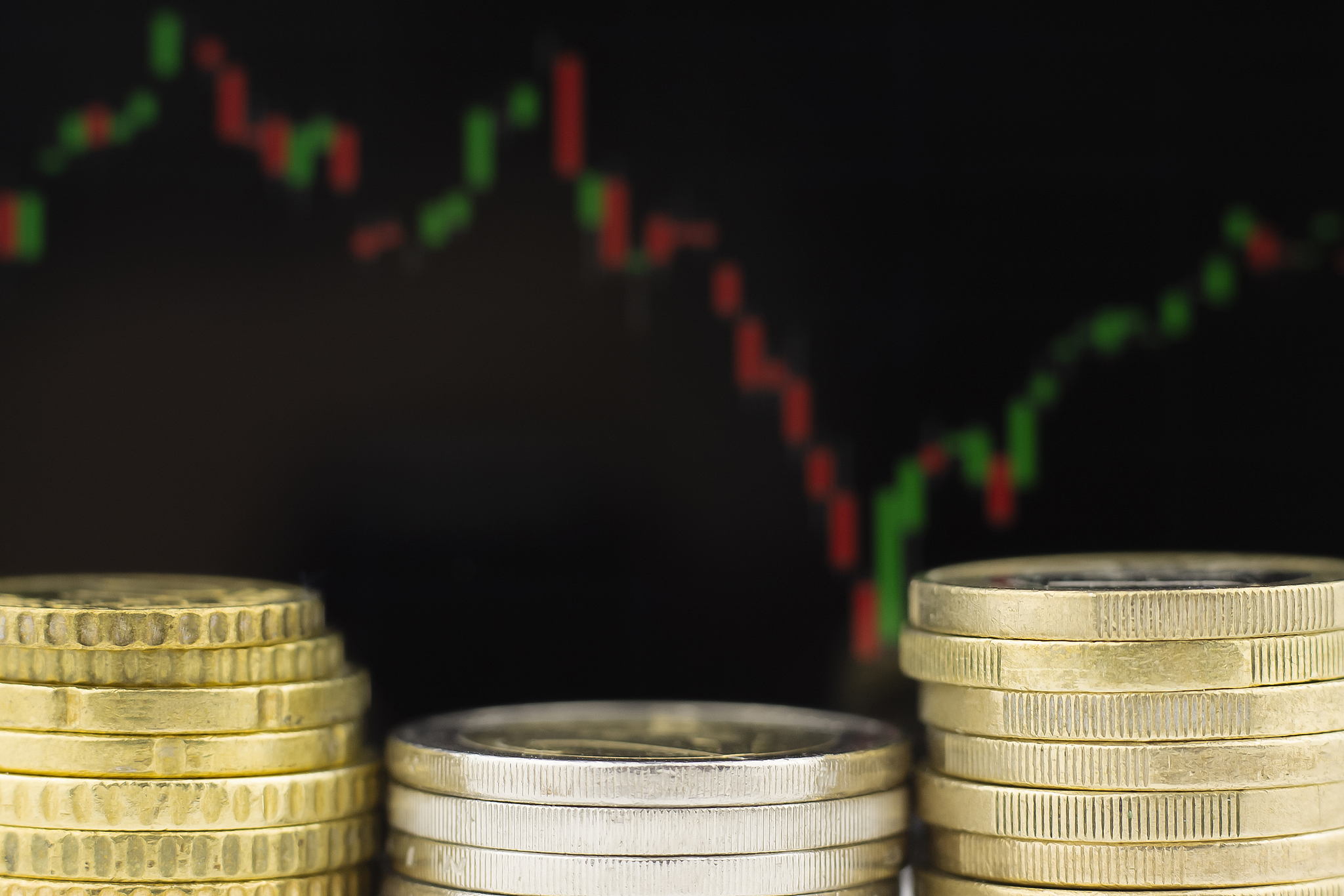 metal coins against the background of the financial schedule.