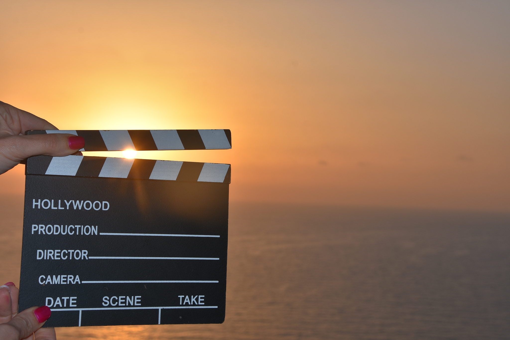 concept - movie clapper at sunset