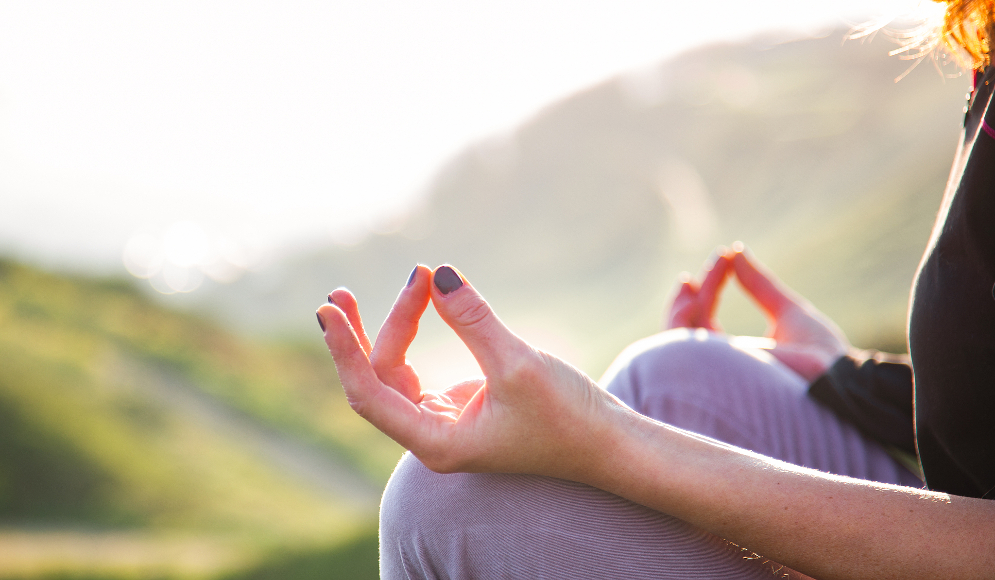 woman doing yoga in beautiful nature background at sunset or sun
