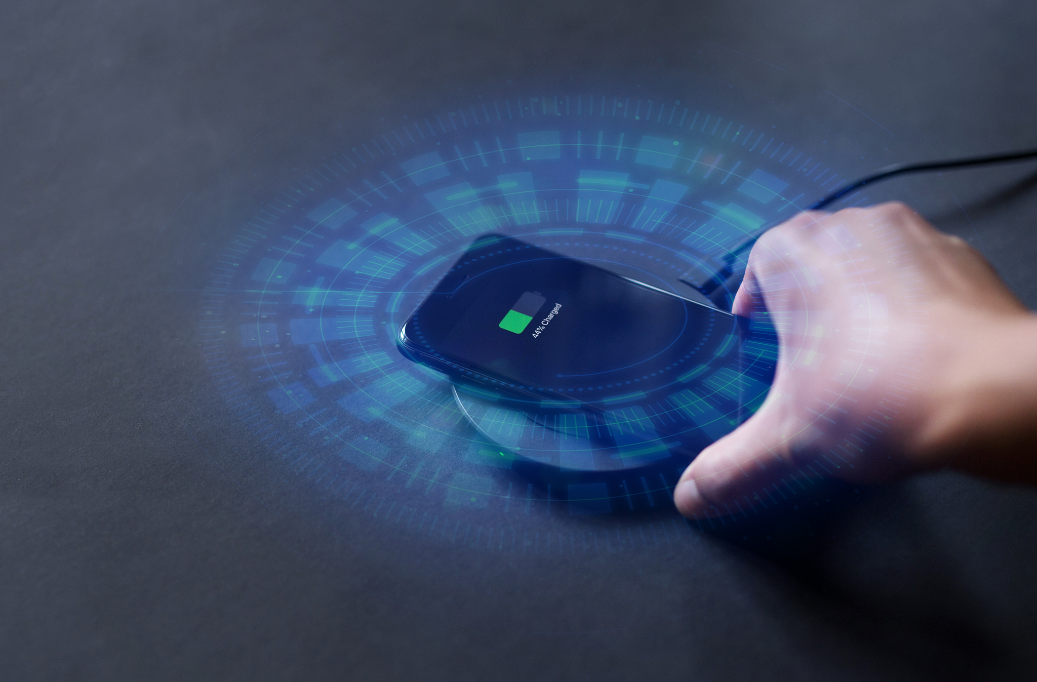 hand that connects the phone to the wireless charger. modern tec