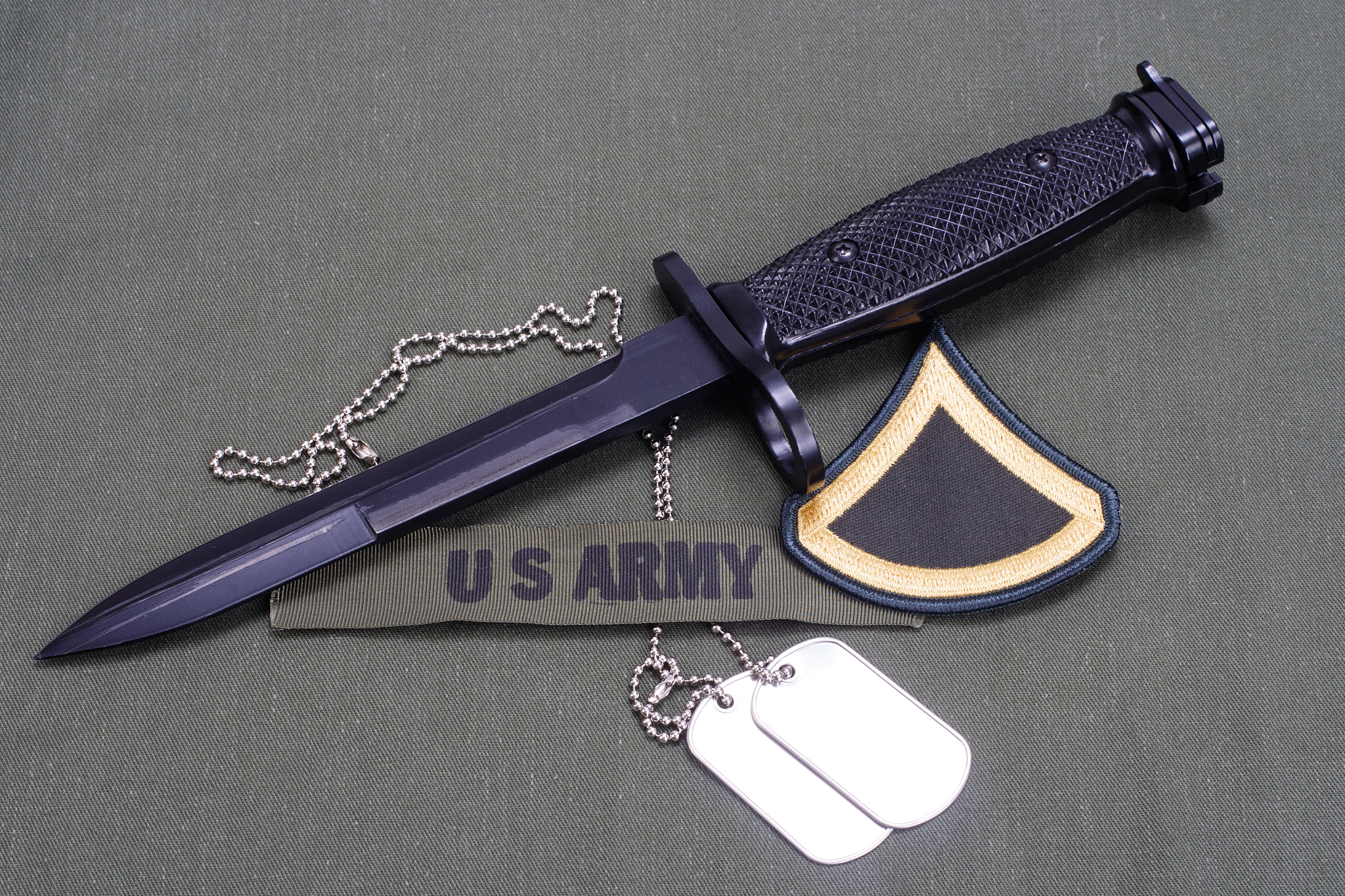 bayonet with dog tags on us army uniform background