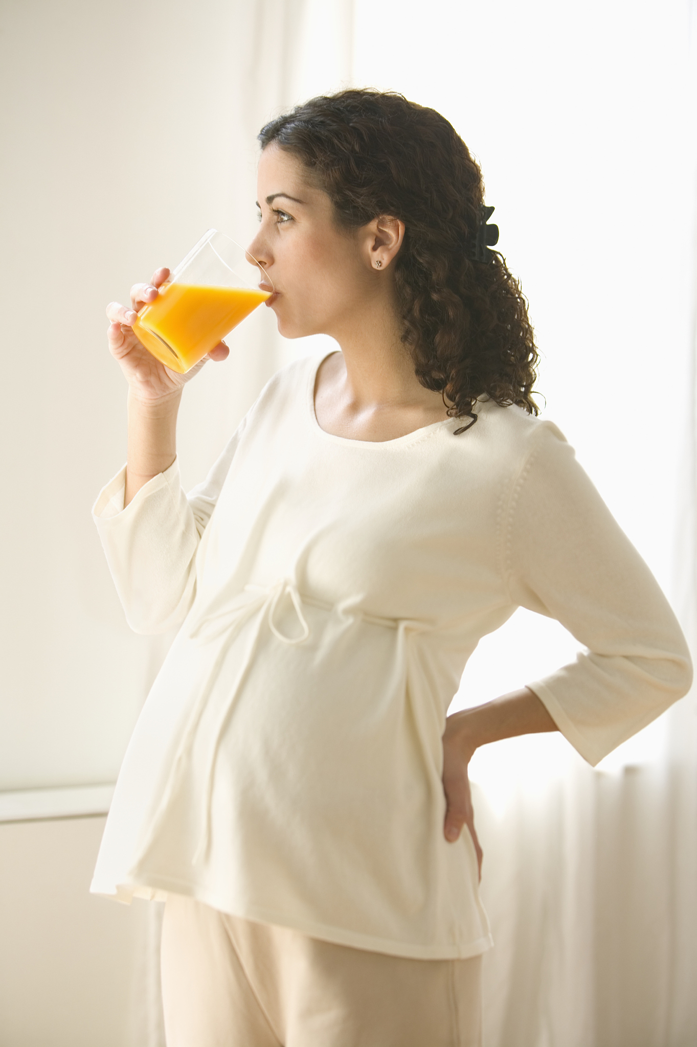 pregnant woman drinking orange juice
