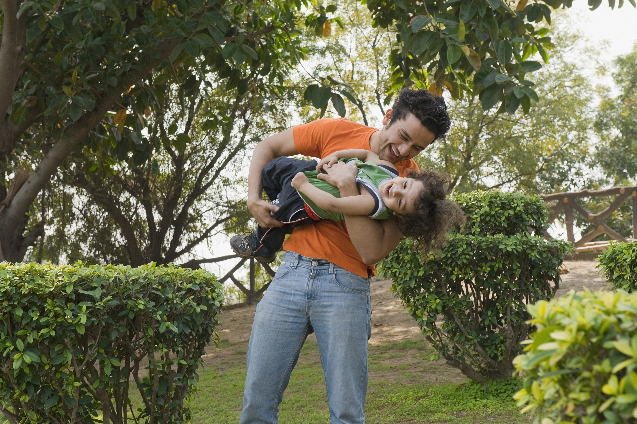 man enjoying with his son in a garden