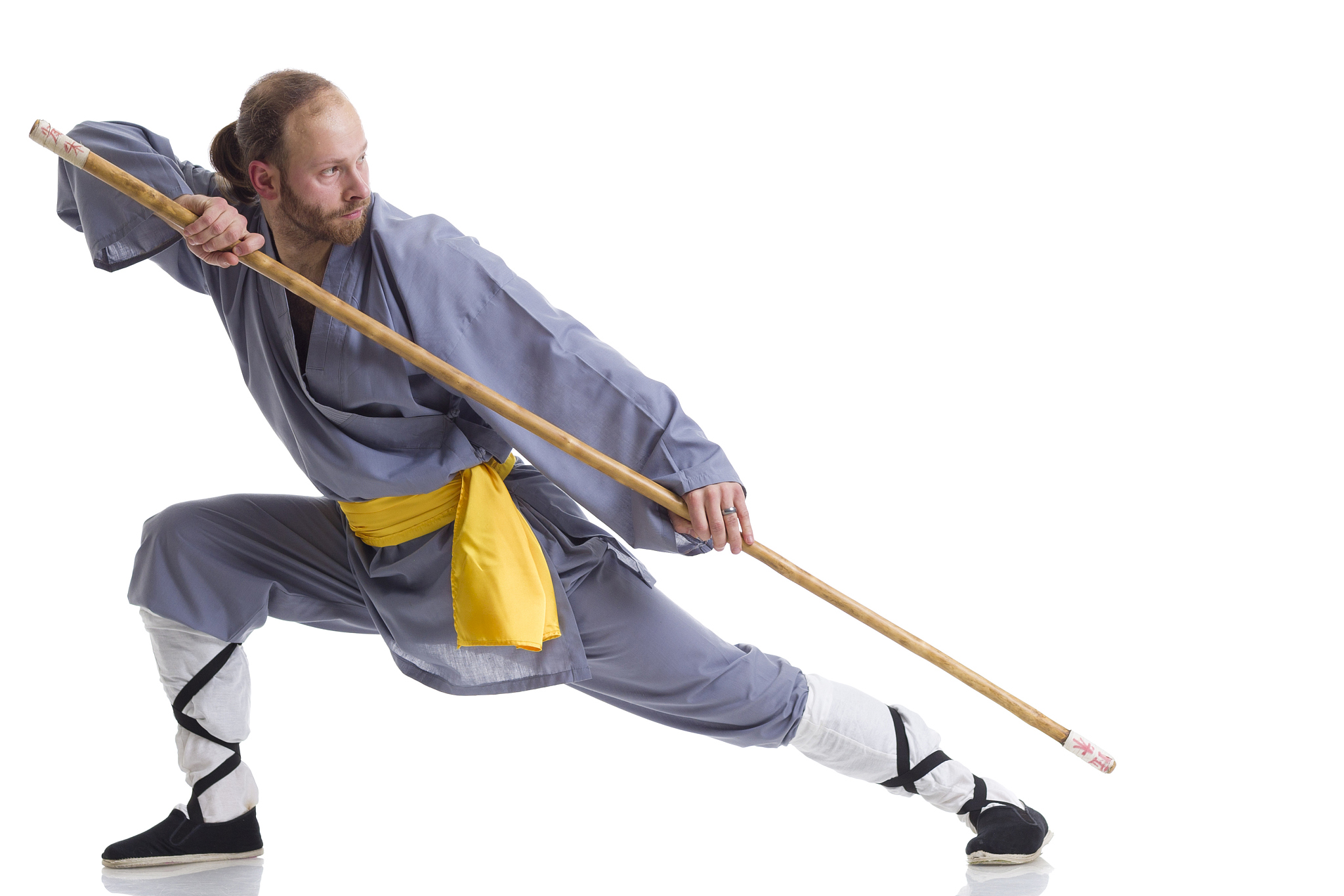 kung fu fighting position with wushu cudgel isolated on white