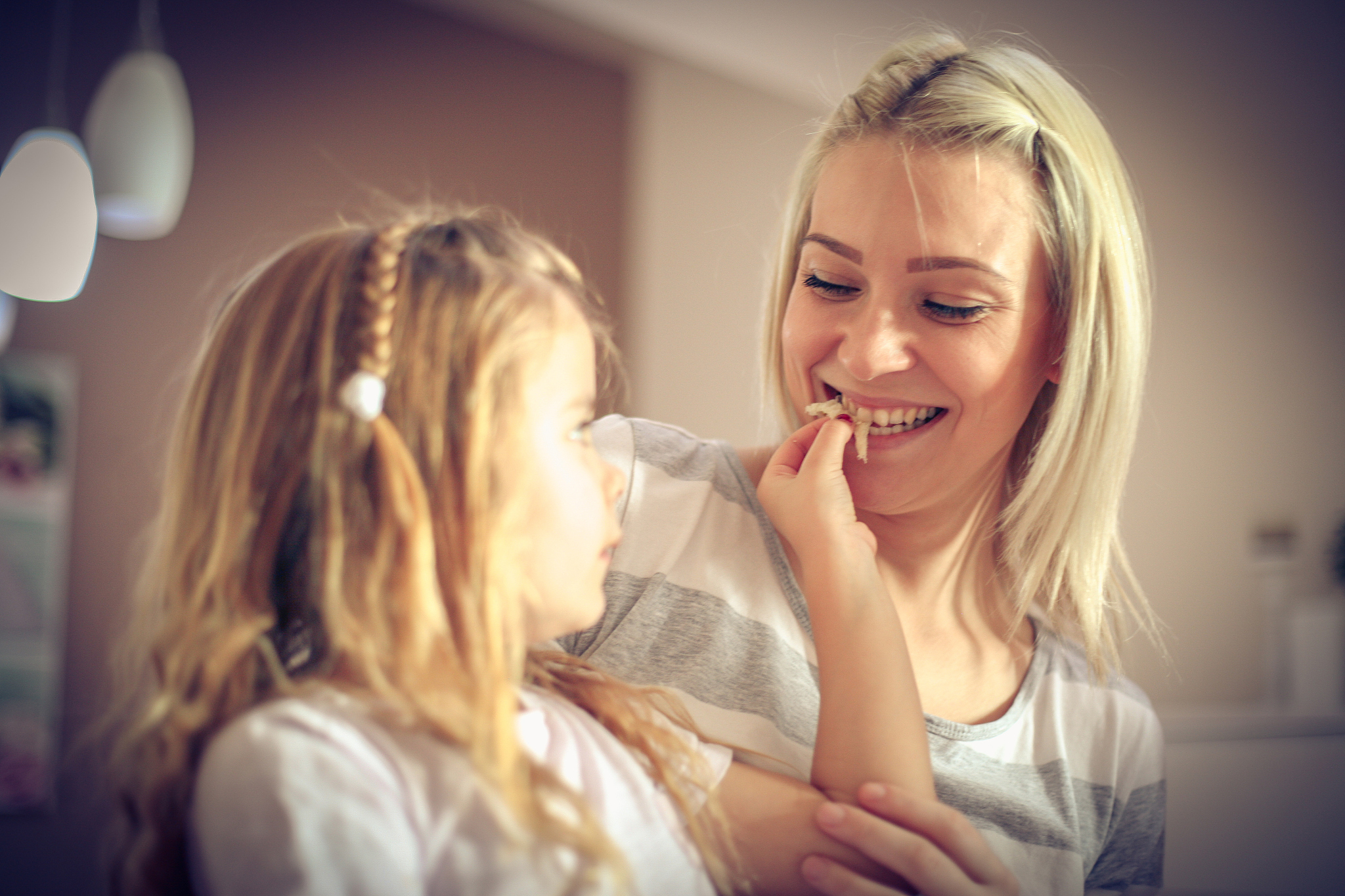 little girl feeds her mother.